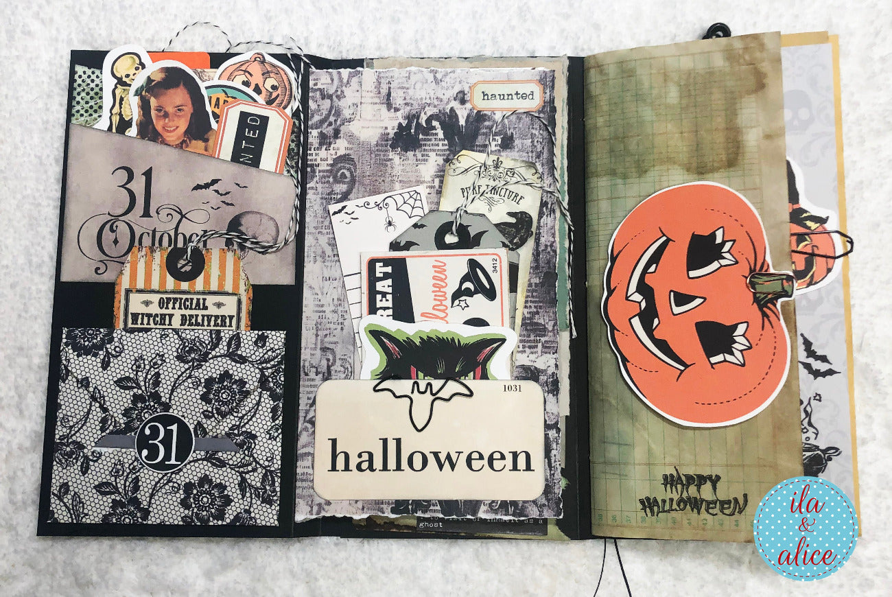 Open folio with Halloween-themed pages featuring pumpkins, cats, and text.