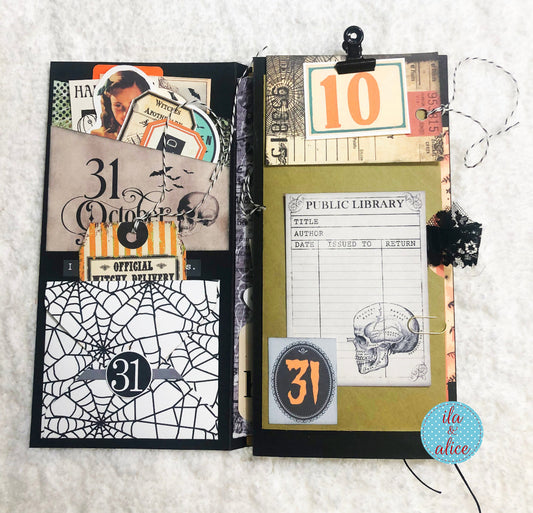 Open junk journal with Halloween-themed pages on a textured white background