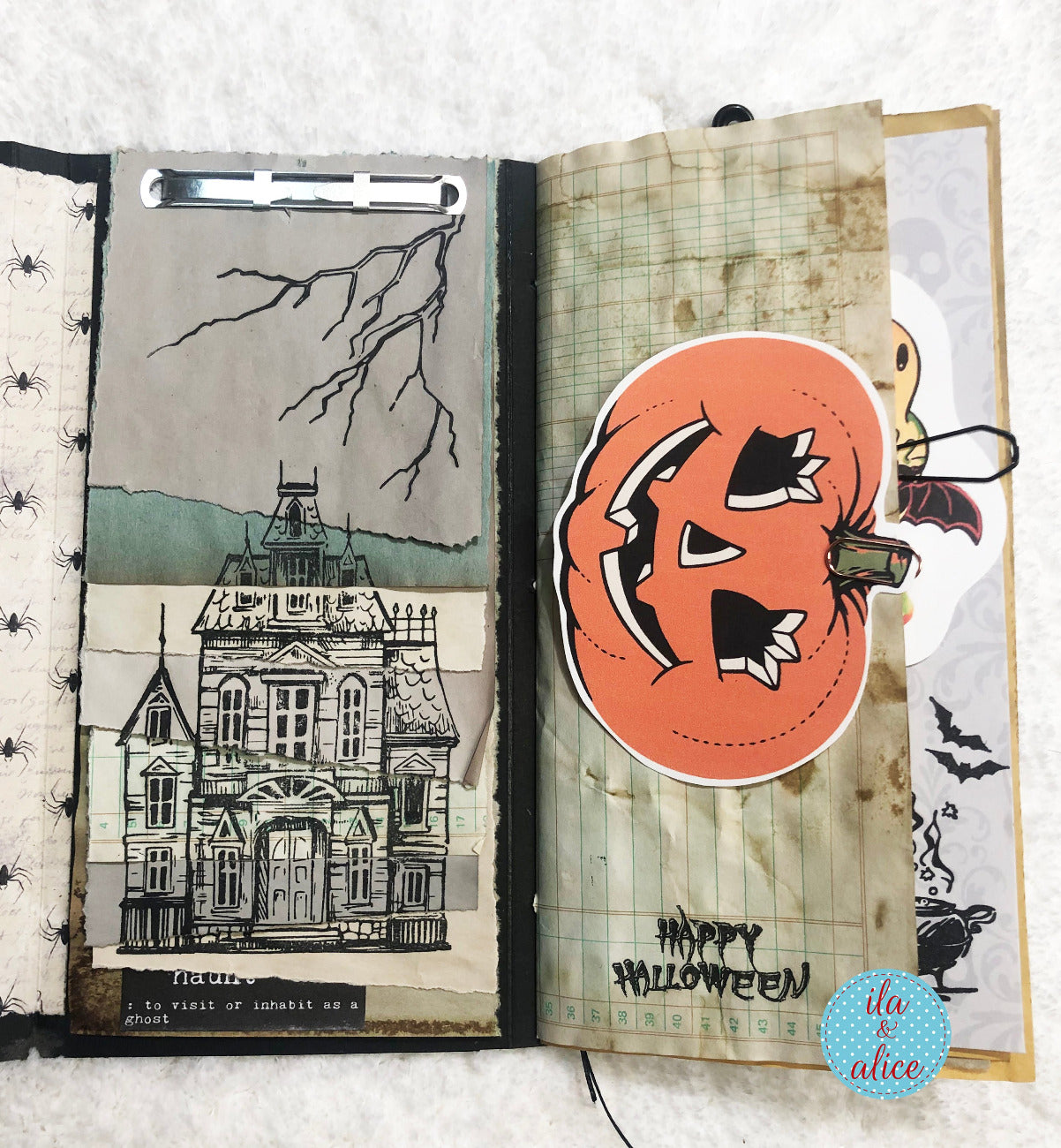 Open book with Halloween-themed pages featuring a haunted house and pumpkin.