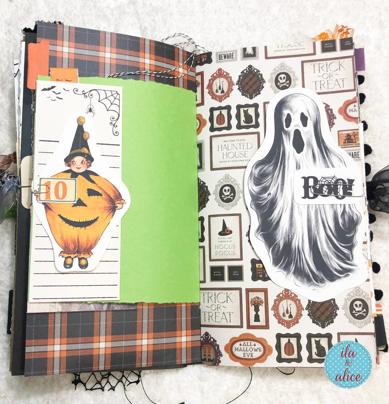 Handmade made Halloween junk journal with ghost and pumpkin designs on a white background