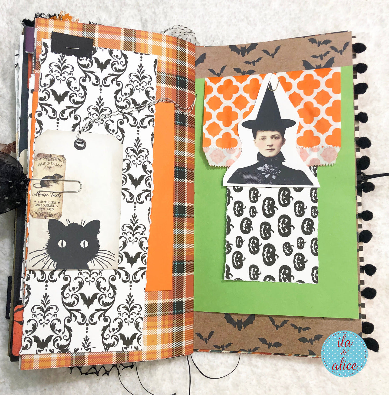 Handmade made Halloween junk journal with Halloween-themed scrapbook page with black cat, plaid patterns, and vintage-style image.