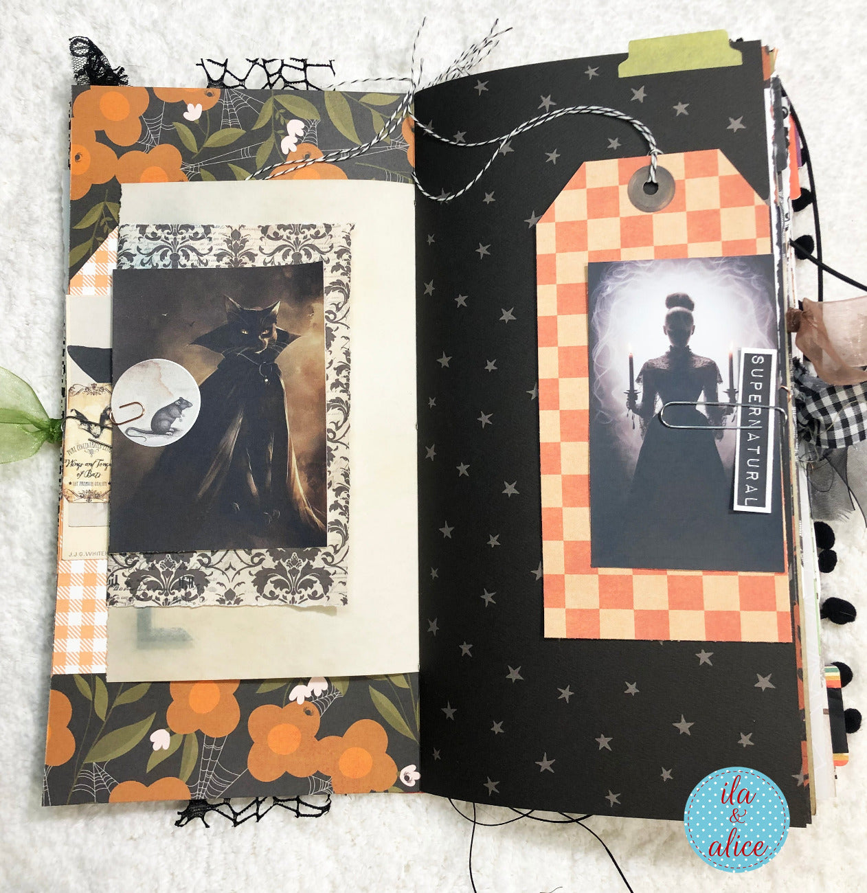 Handmade made Halloween junk journal with Halloween-themed pages featuring black and white silhouettes and decorative elements.