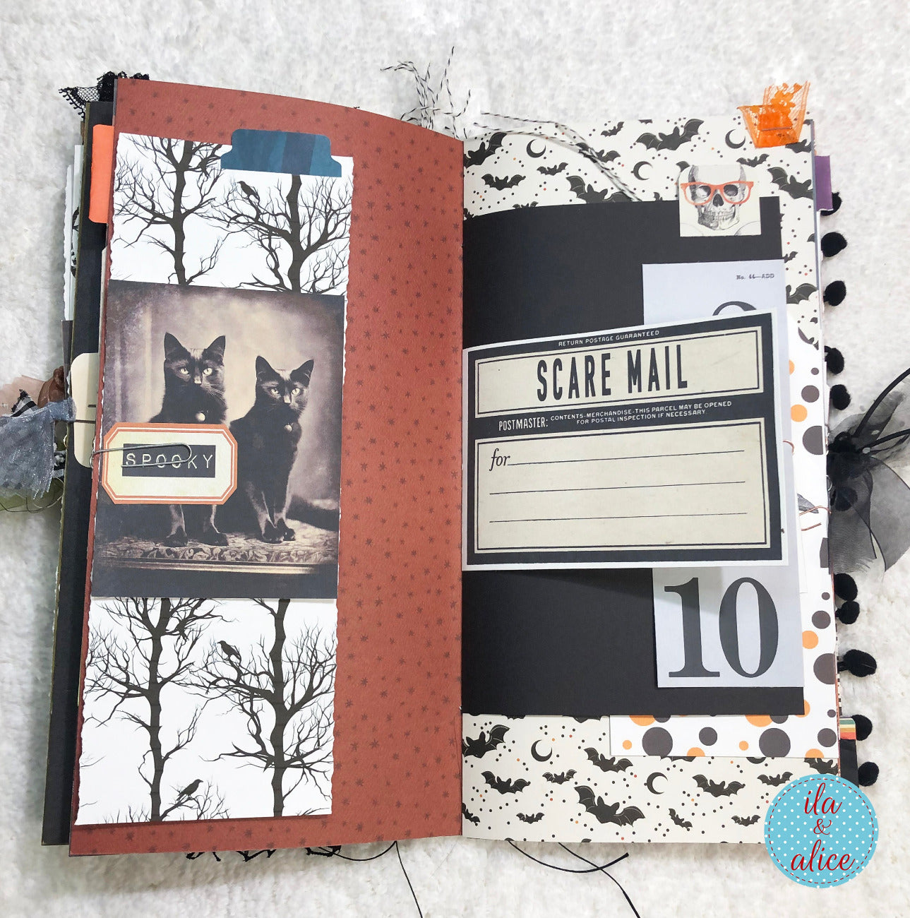 Handmade made Halloween junk journal notebook with Halloween-themed pages featuring black cats and decorative text.