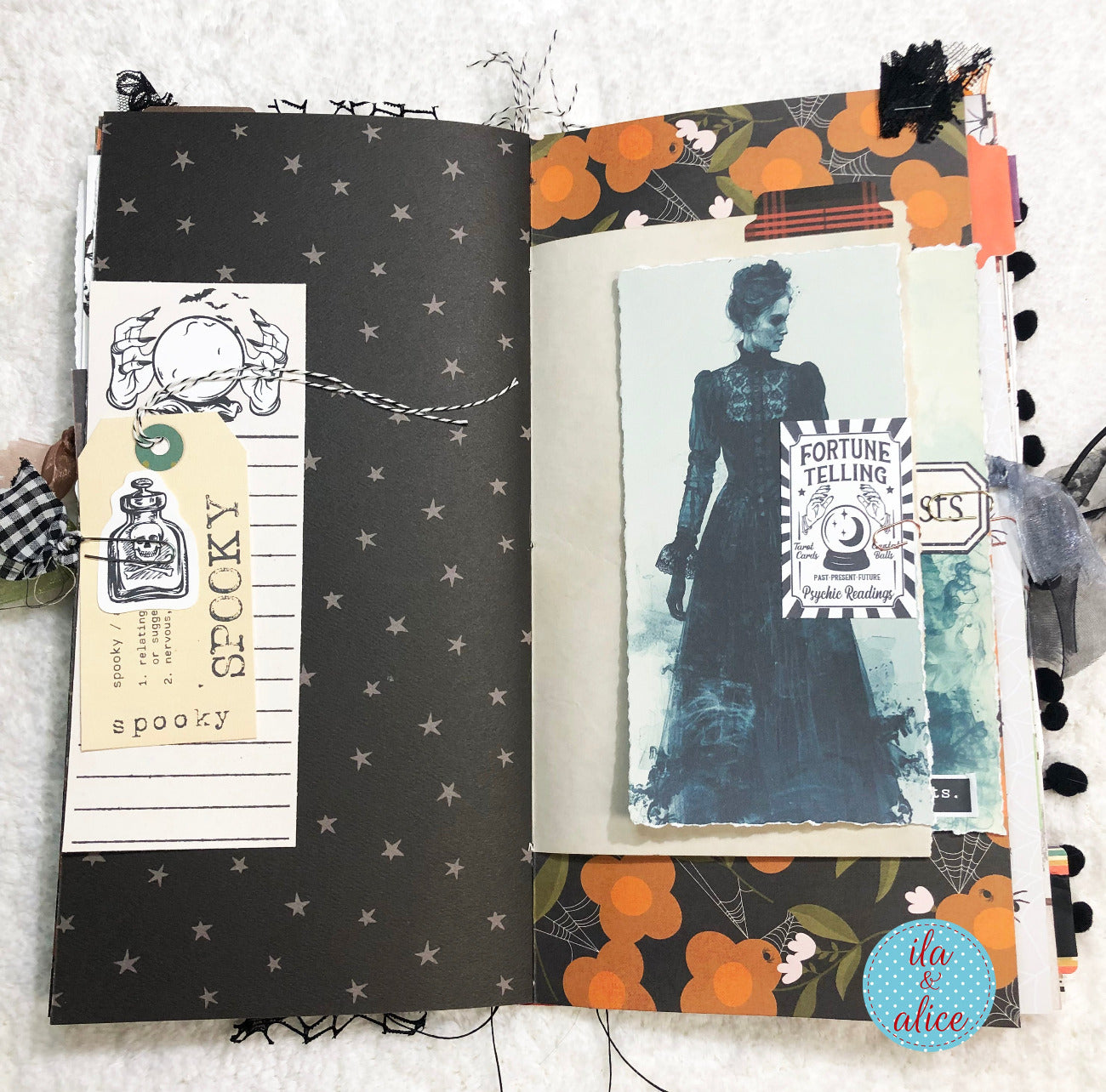 Handmade made Halloween junk journal with Halloween-themed pages featuring a fortune teller and decorative elements.