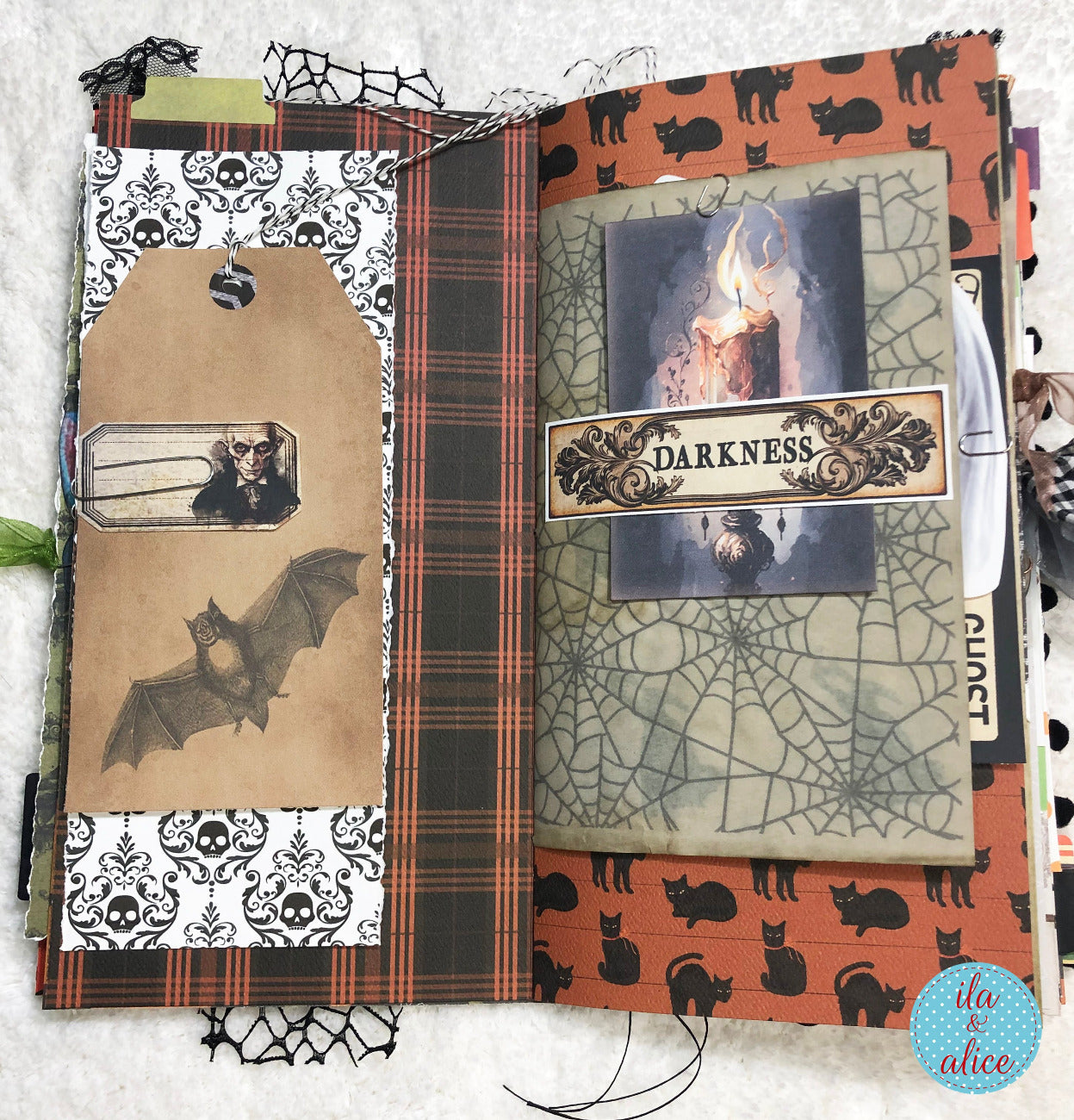 Handmade made Halloween junk journal w Halloween-themed scrapbook page with spider web, bats, and cats.