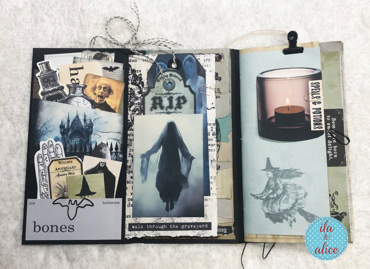 Open folio with Halloween-themed collage on a textured surface
