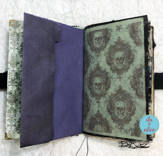 Open book with skull pattern on a textured surface