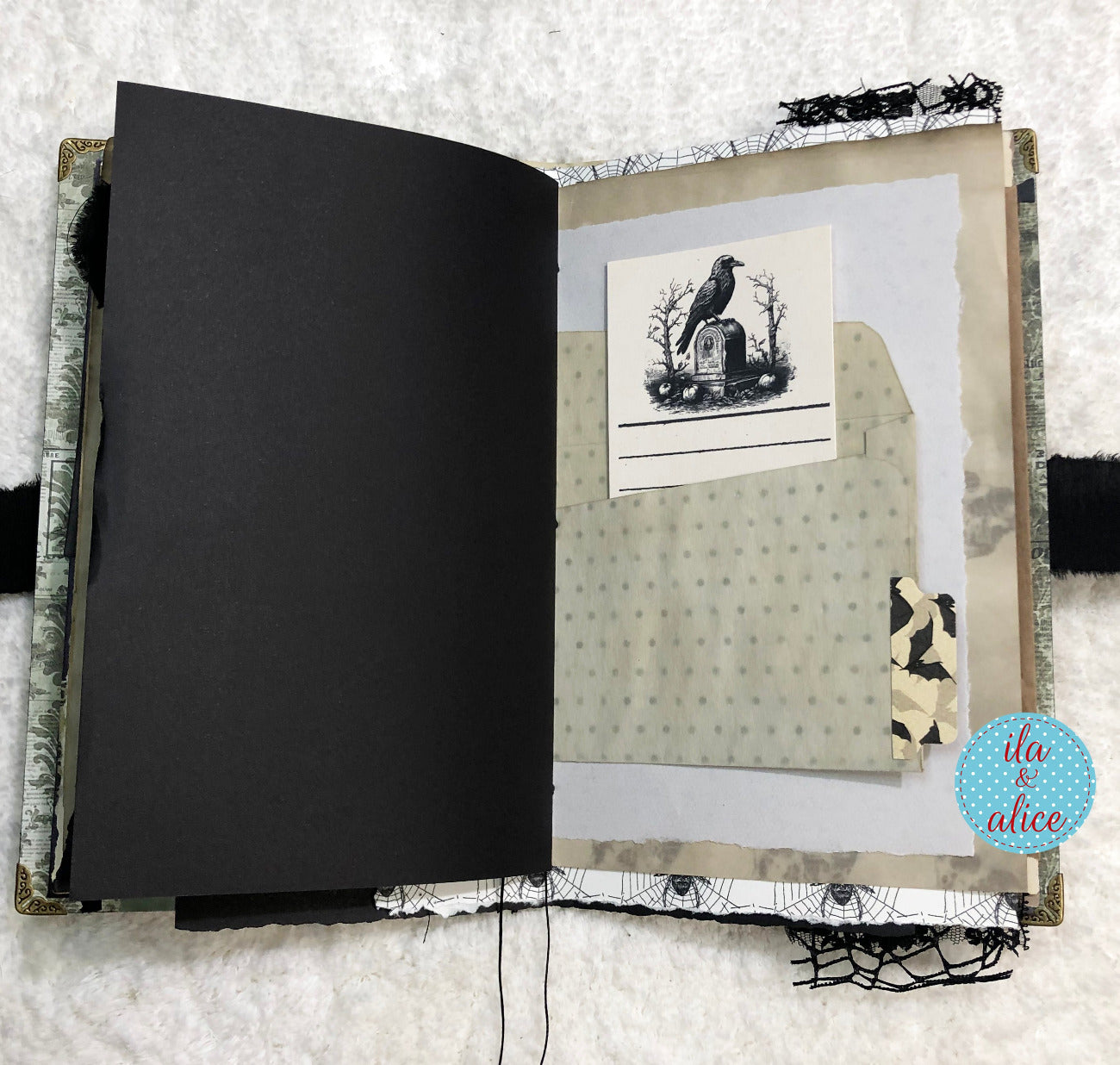 Handmade Eerie Halloween Gothic junk journal with black pages and decorative cover on a textured surface