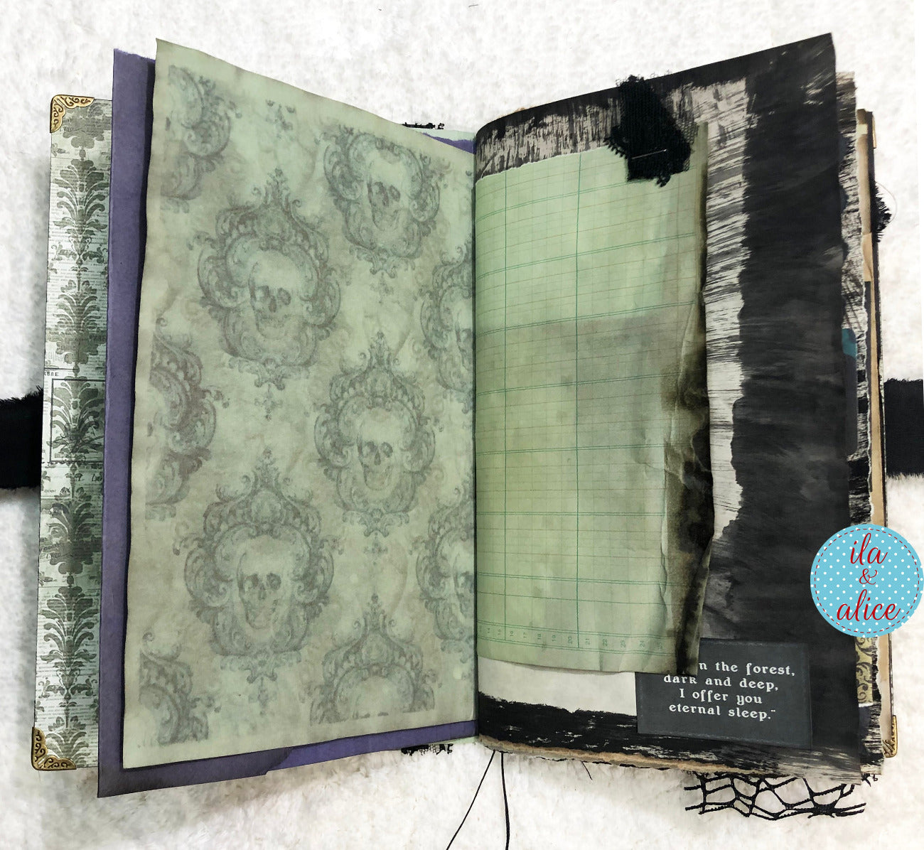 Handmade Eerie Halloween Gothic junk journal with decorative skull patterns and grid pages on a textured surface.