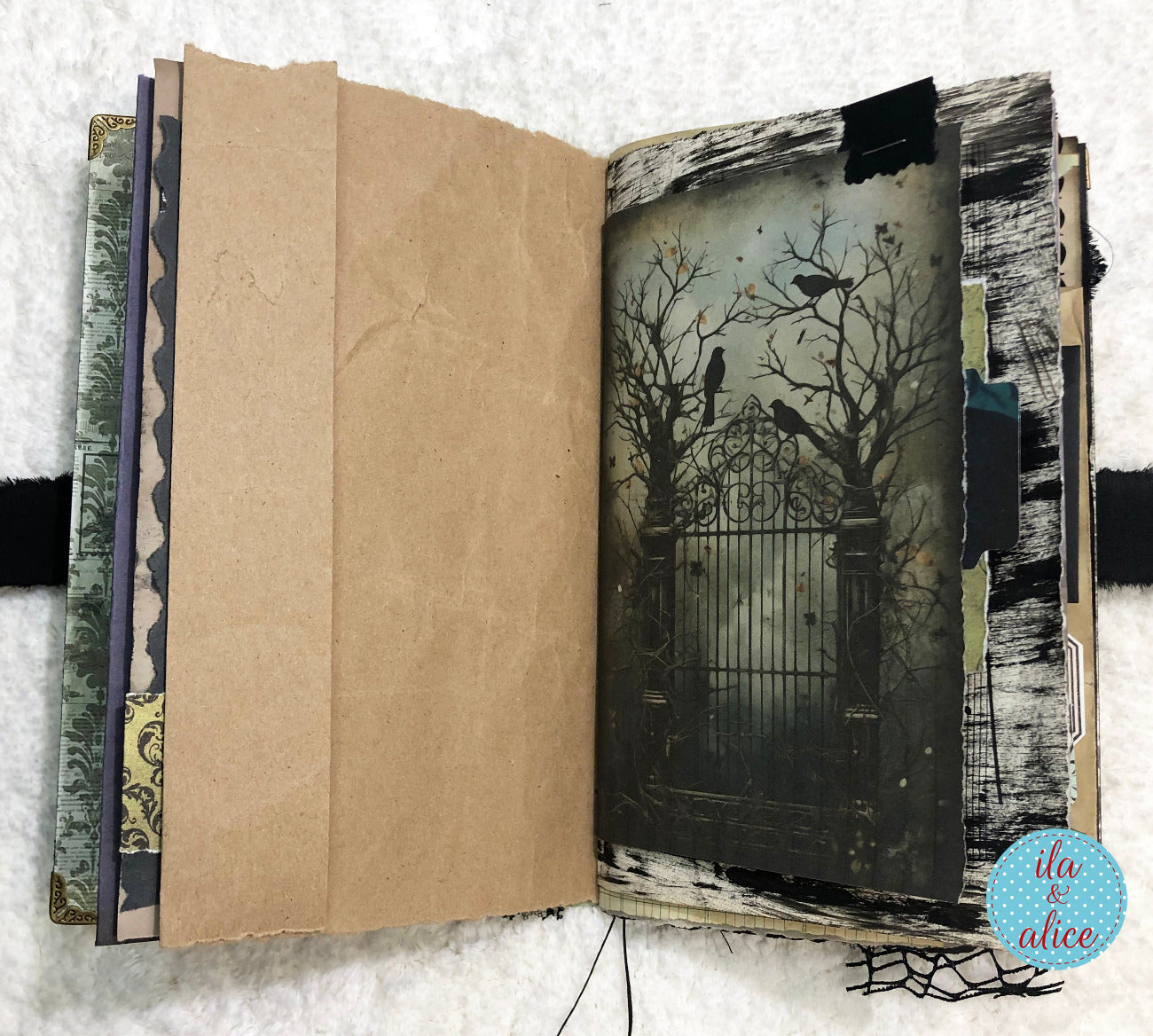 Handmade Eerie Halloween Gothic junk journal with a dark, artistic illustration of a gate and trees on a textured white background