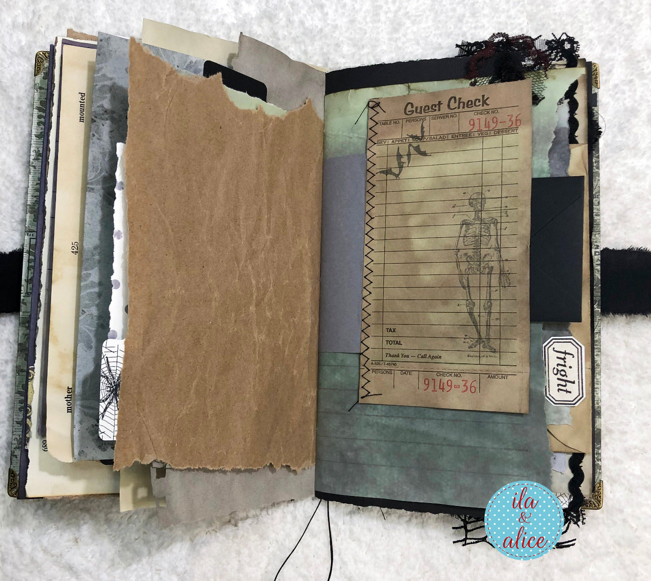 Handmade Eerie Halloween Gothic junk journal with textured pages and vintage-style design elements on a white background.