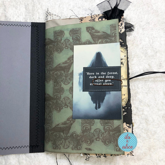 Handmade Halloween junk journal with a scary ghost and text on a textured surface