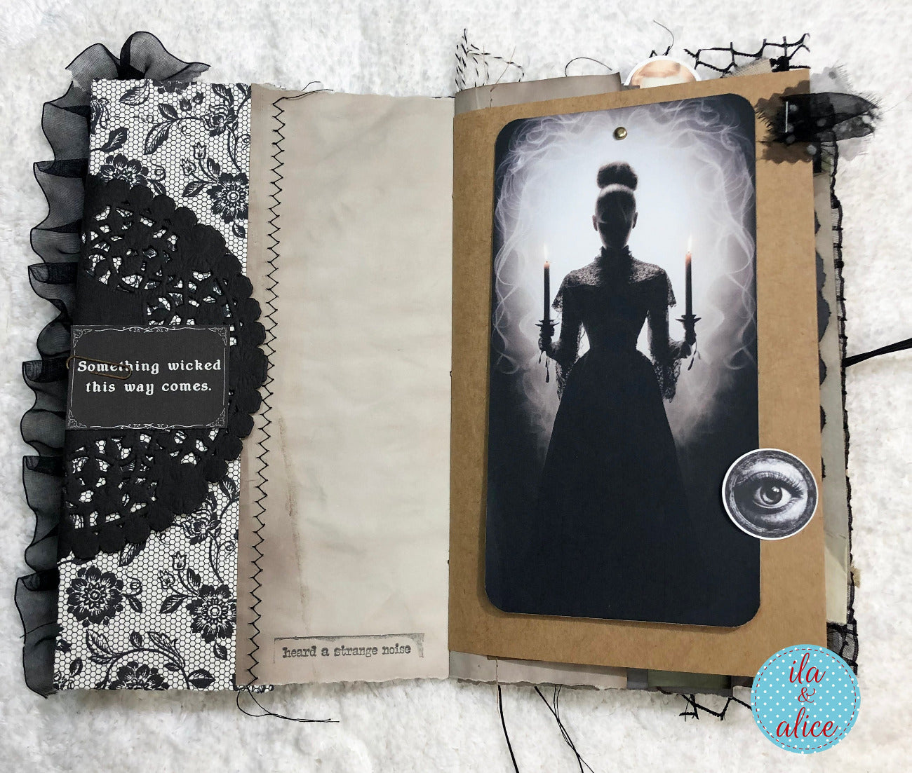 Gothic-themed scrapbook page with silhouette of a woman holding candles and decorative elements.