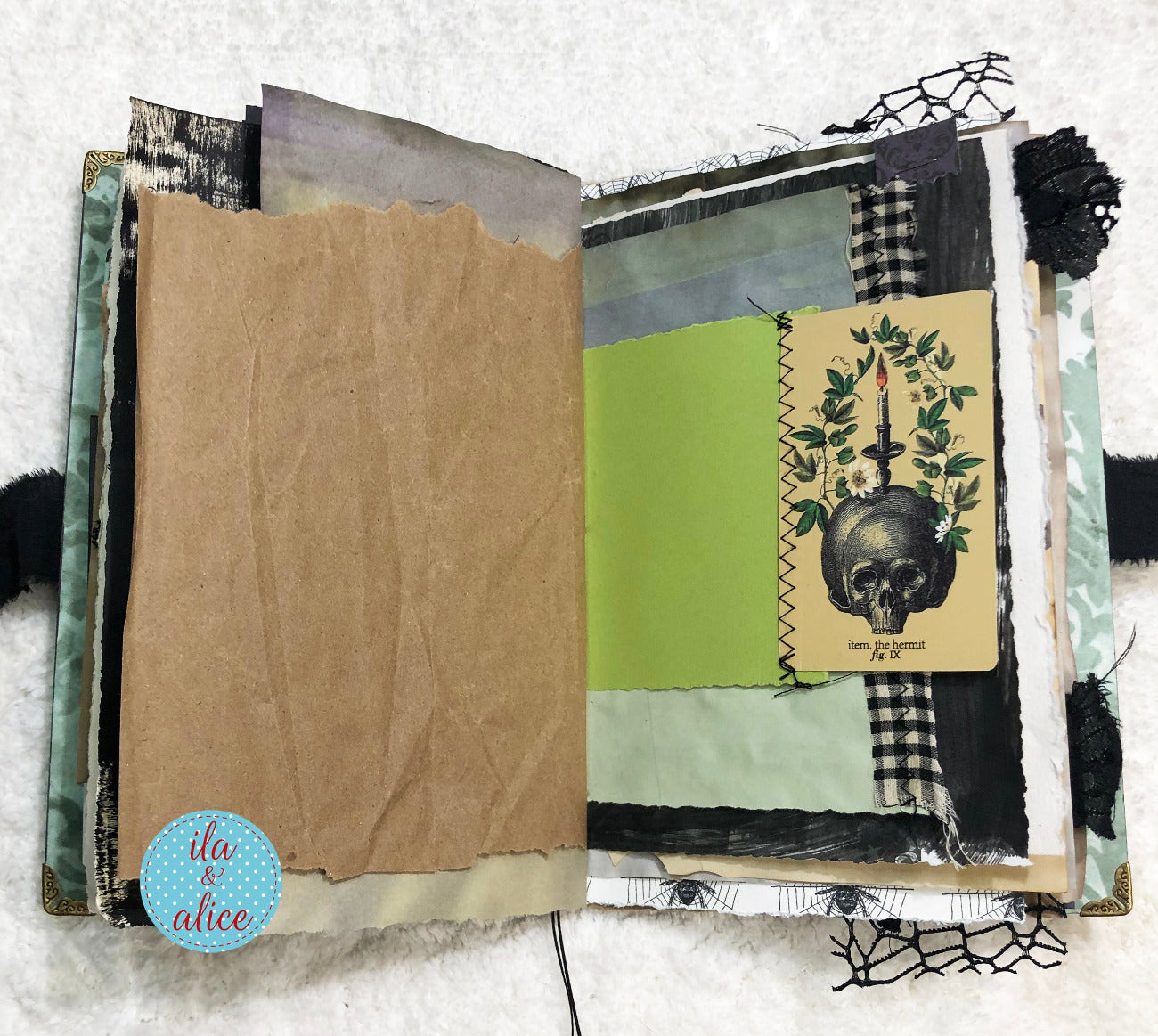 Handmade Eerie Halloween Gothic junk journal with textured pages and decorative elements on a white background