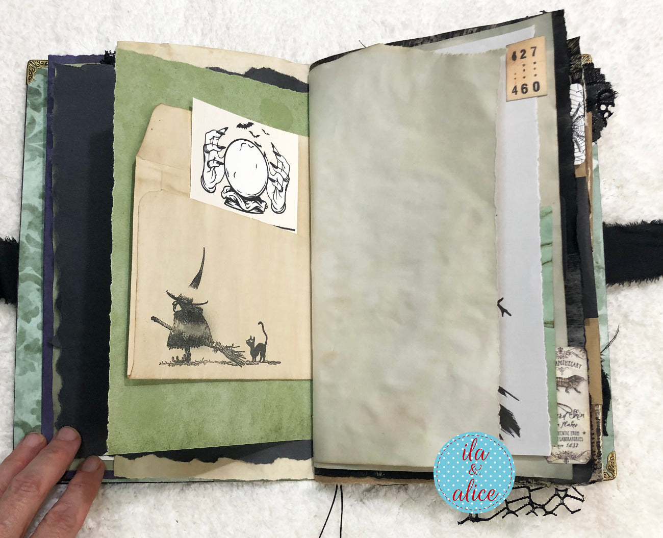 Open book with illustrations and text, held by a hand on a textured surface.