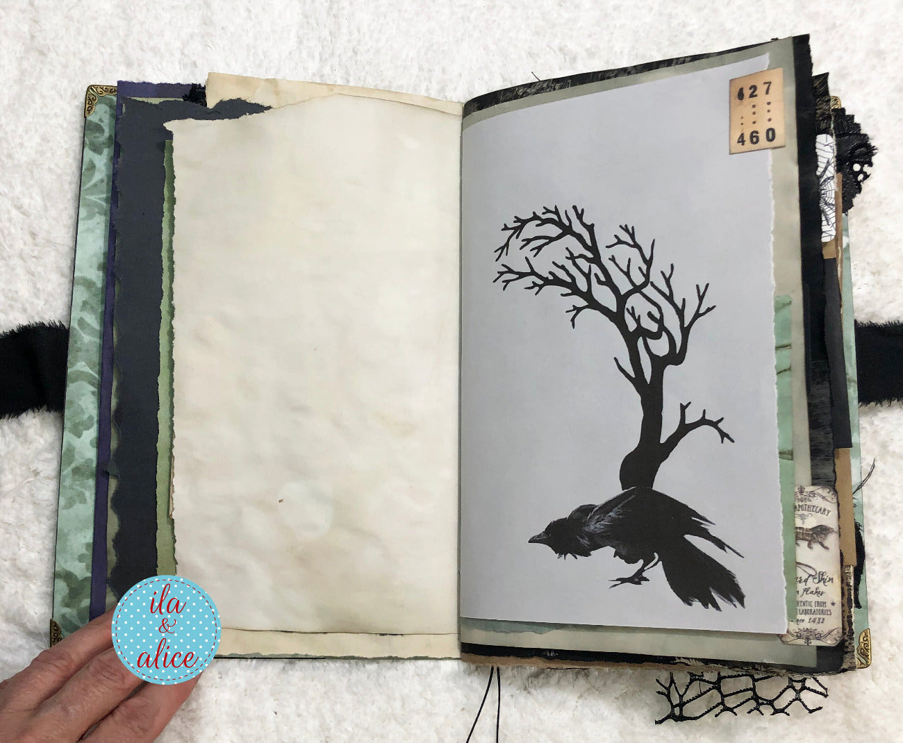Handmade Eerie Halloween Gothic junk journal with a black silhouette of a tree and a bird on a white background