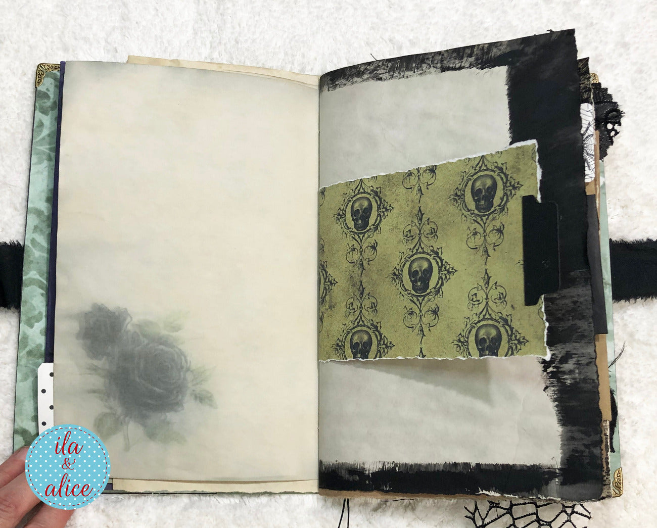 Handmade Eerie Halloween Gothic junk journal with decorative pages featuring skull patterns and black and white design elements.
