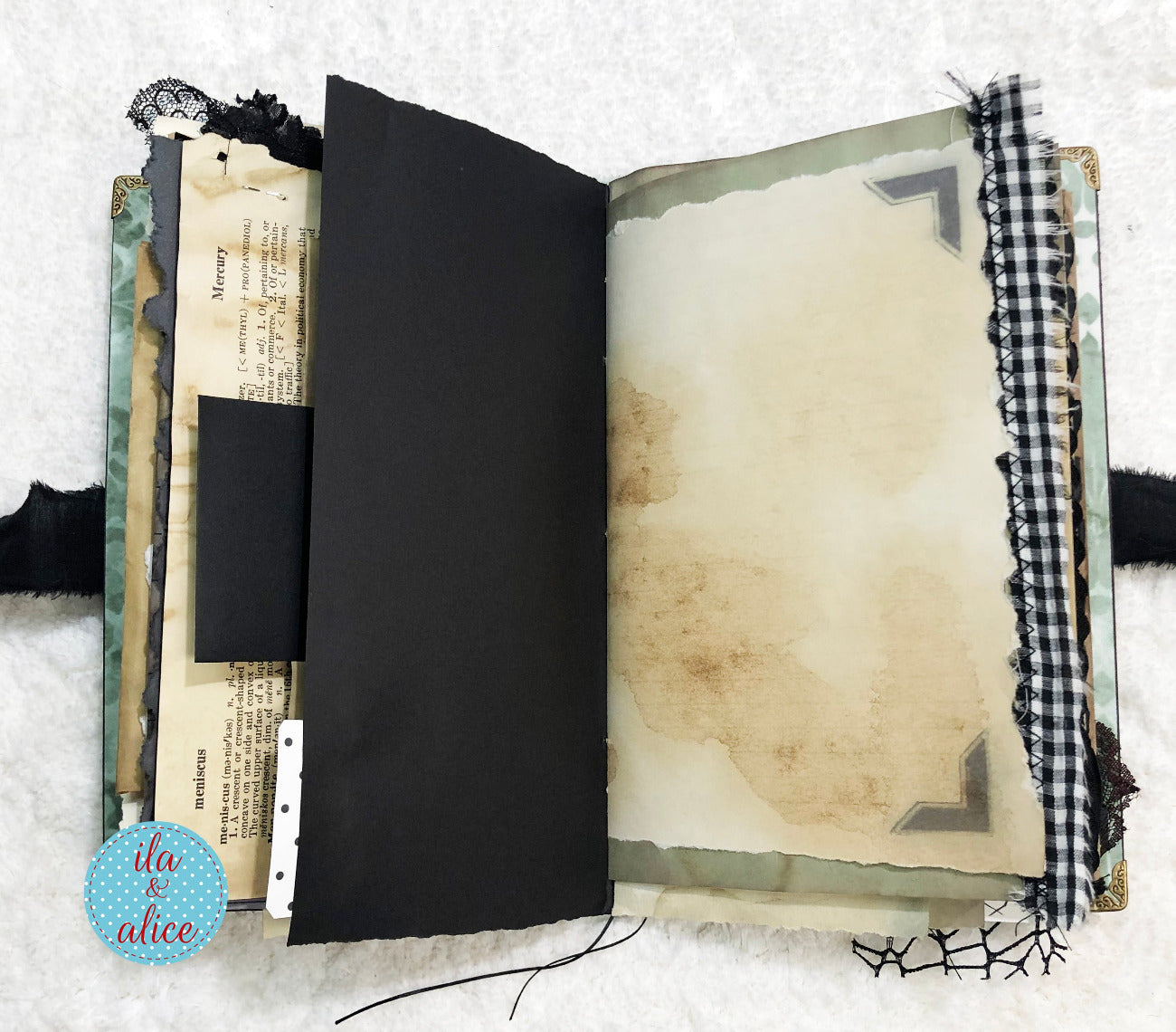 Handmade Eerie Halloween Gothic junk journal with textured pages and decorative elements on a white background