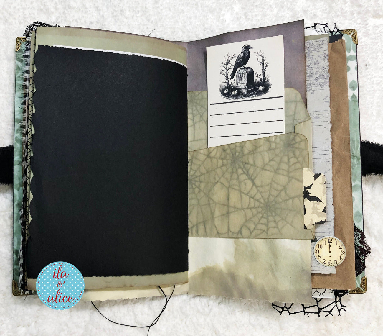 Handmade Eerie Halloween Gothic junk journal with textured pages and decorative elements on a white surface
