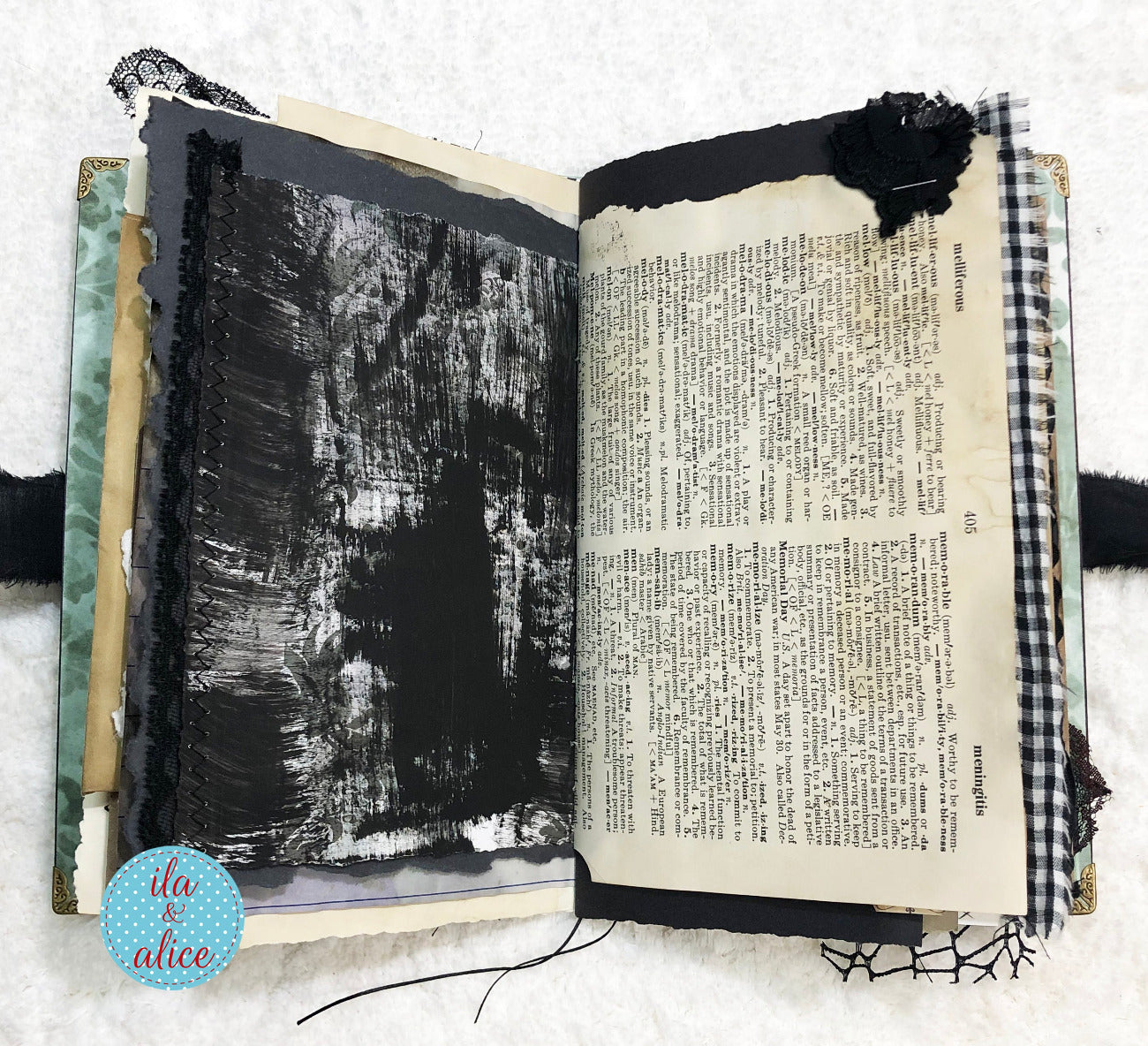 Open book with black abstract art on one page and text on the other, on a textured white background.