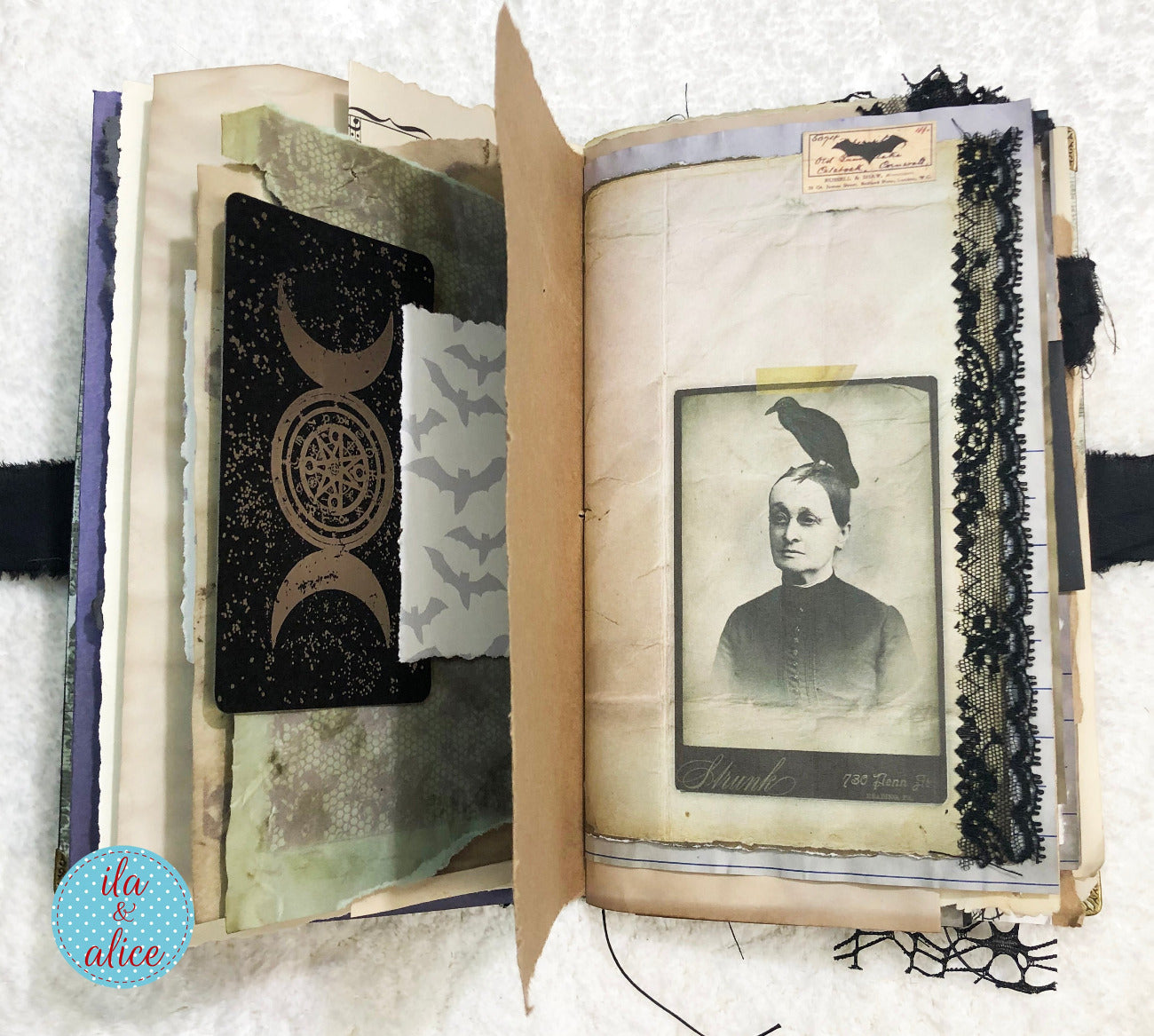 Handmade Eerie Halloween Gothic junk journal with vintage photo and decorative elements on a textured surface