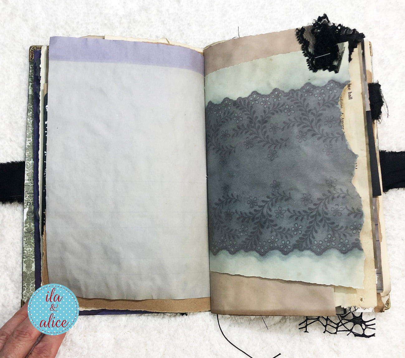 Handmade Eerie Halloween Gothic junk journal with decorative pages featuring lace and fabric textures, held by a hand.