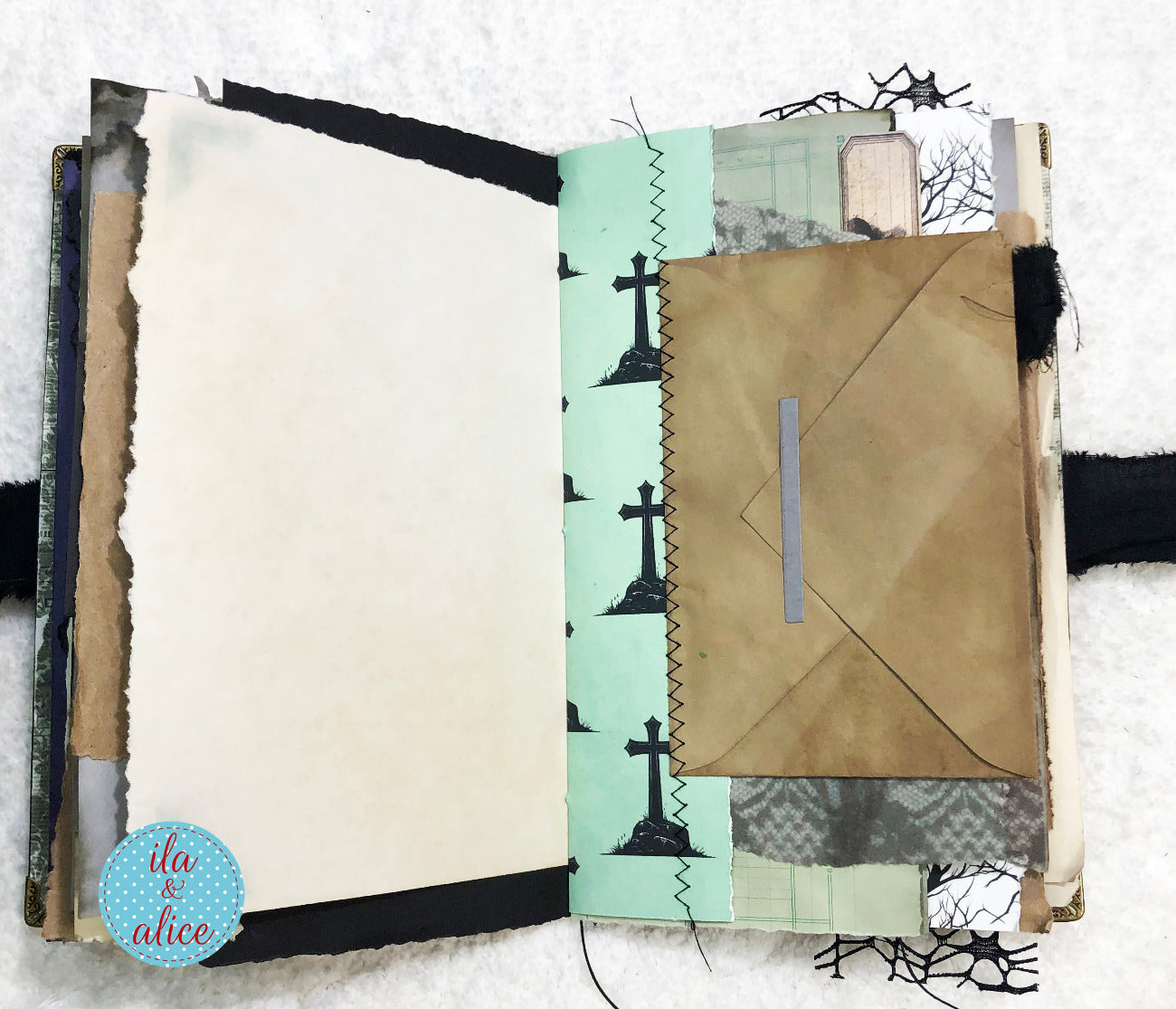 Handmade Eerie Halloween Gothic junk journal with textured pages and decorative elements on a white background
