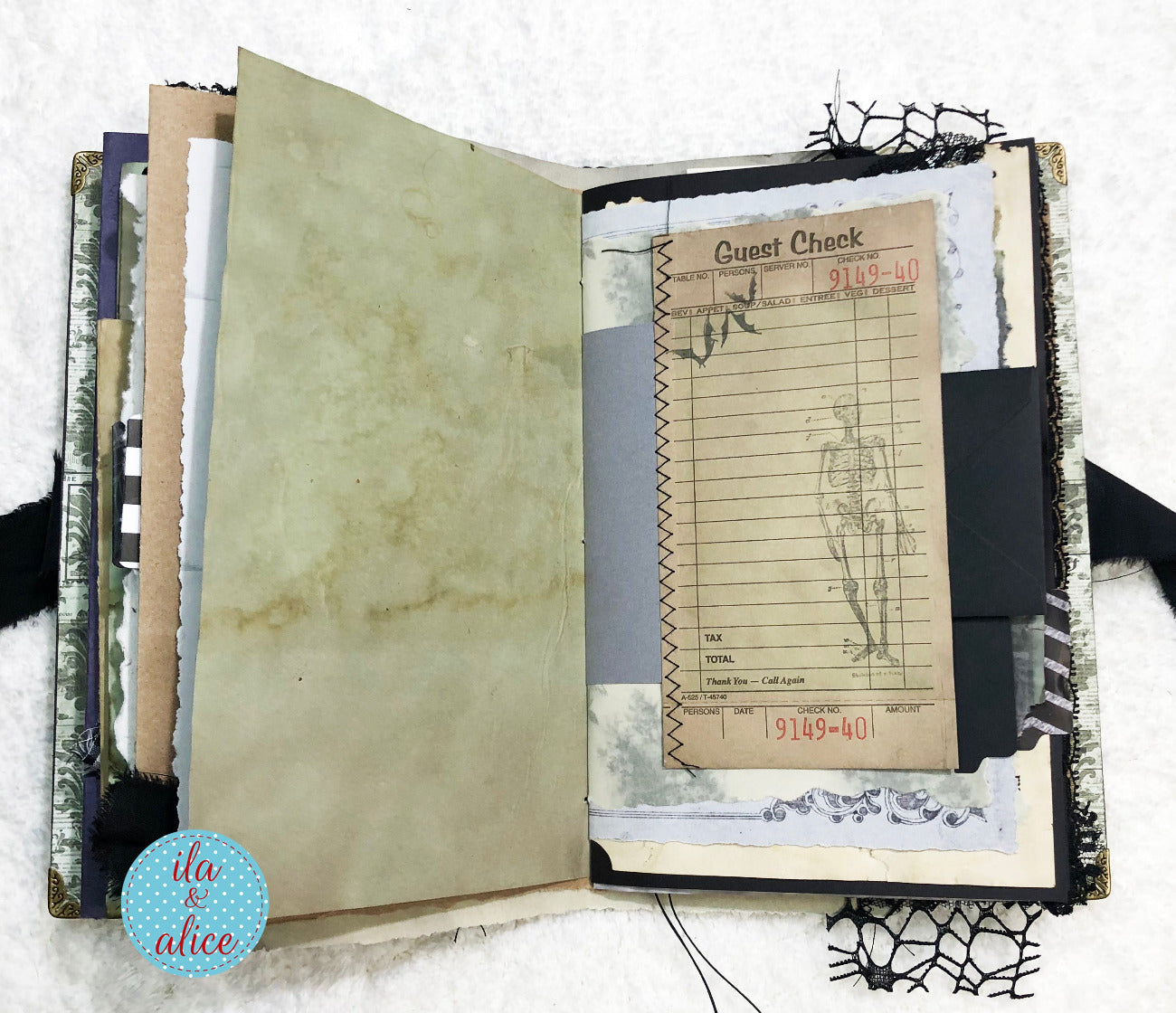 Handmade Eerie Halloween Gothic junk journal with vintage-style pages and a visible brand logo in the corner.