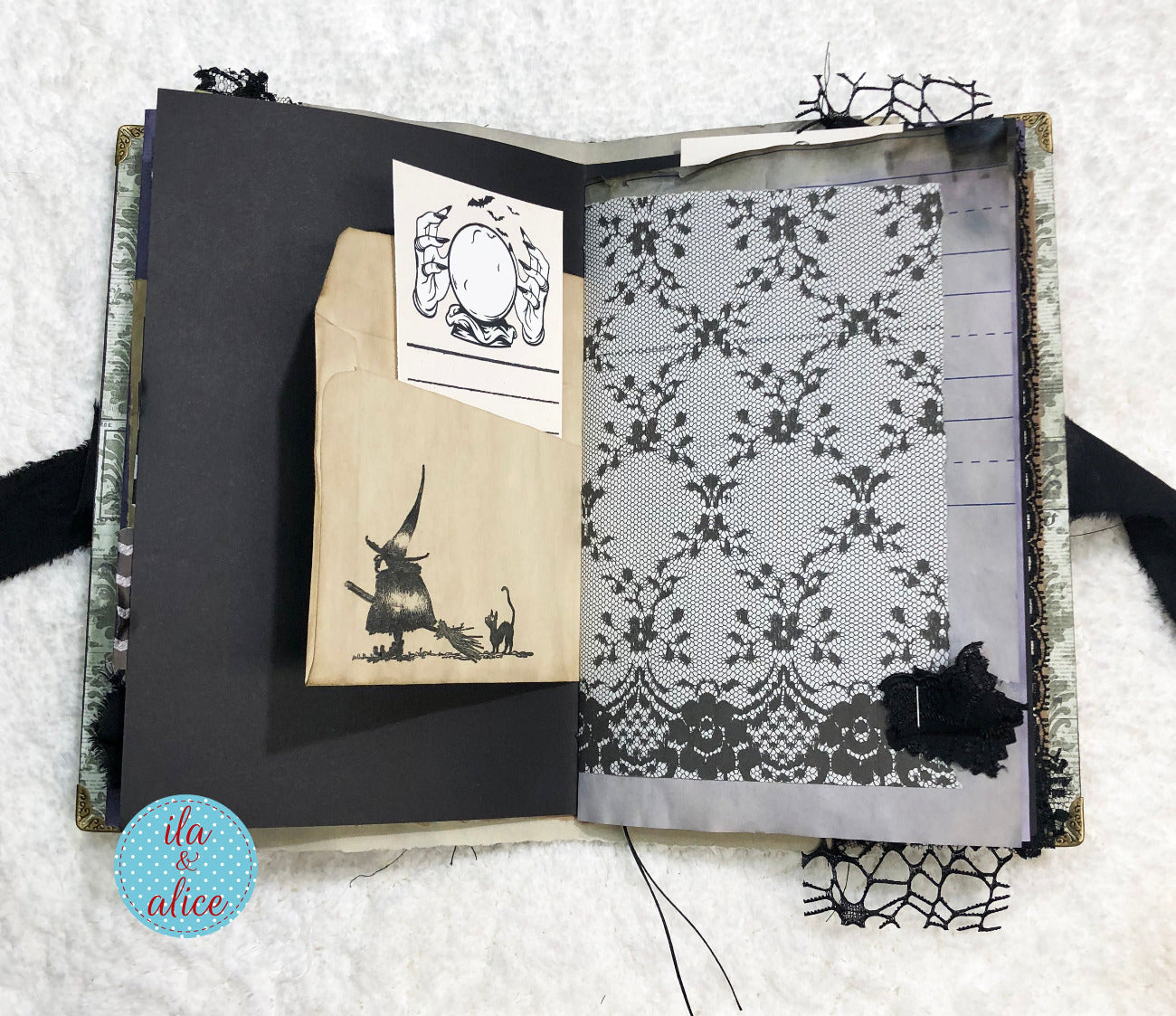 Handmade Eerie Halloween Gothic junk journal with black and white illustrations and patterns on a textured surface.