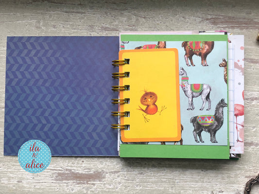 Handmade mini journal inside pages with vintage and vintage-inspired papers