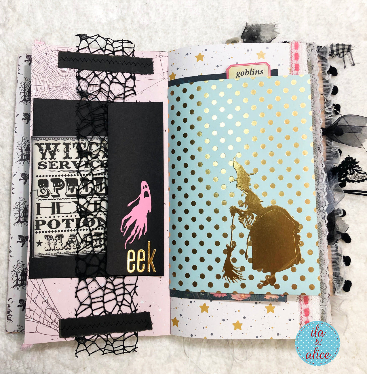 Handmade Pink and Black Halloween junk journal witch and ghost with decorative covers on a textured surface
