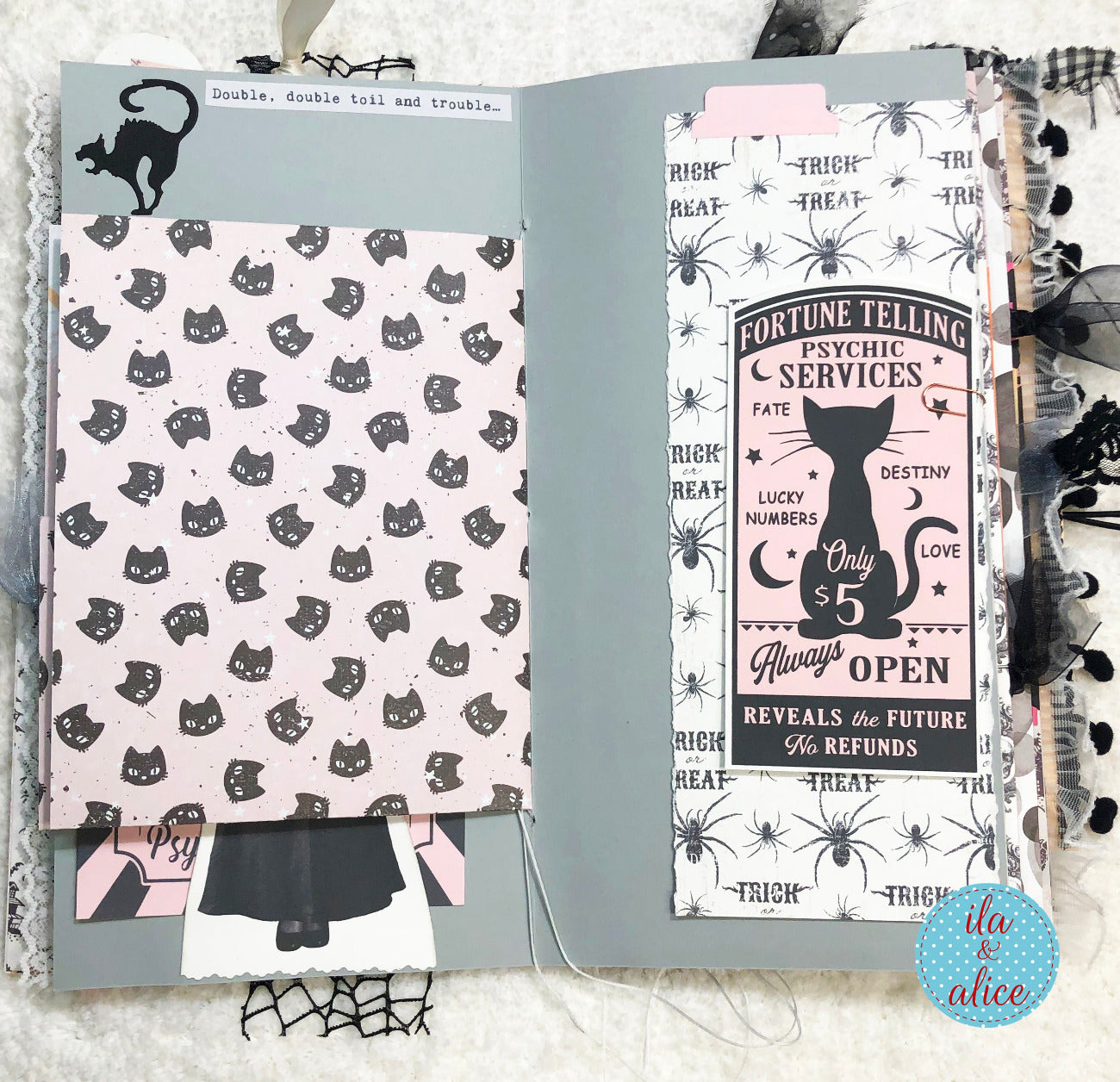 Handmade Pink and Black Halloween junk journal with black cat and fortune teller design on a textured surface