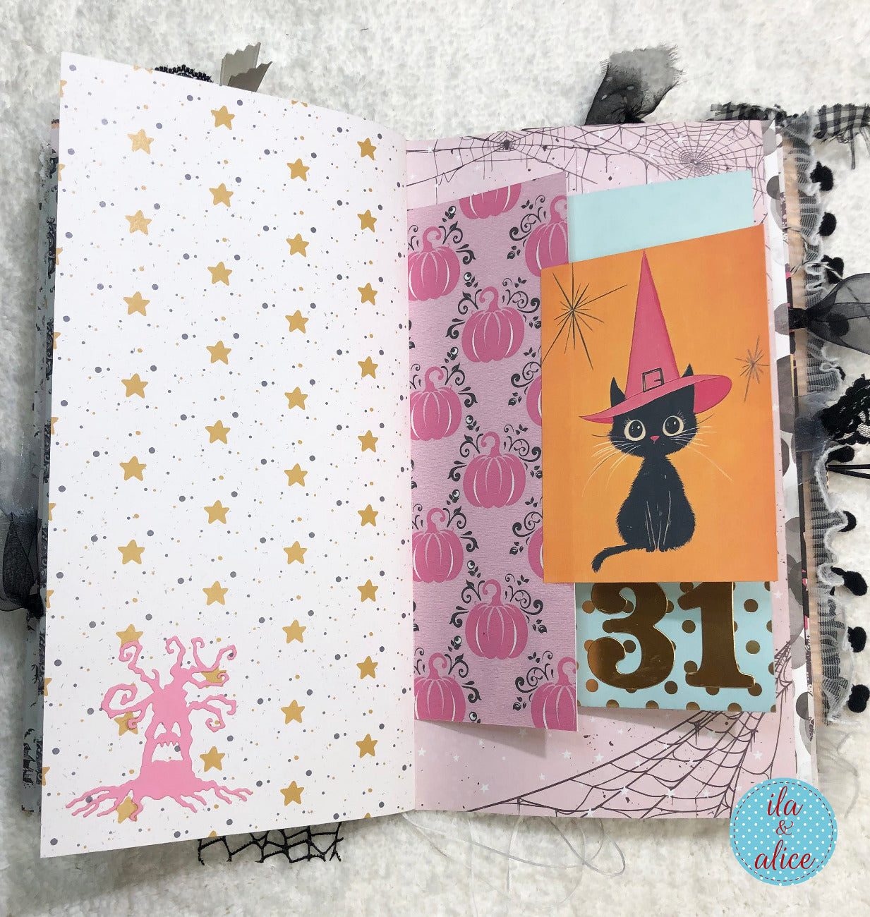 Handmade Pink and Black Halloween junk journal featuring a black cat in a witch hat, pumpkins, and stars.