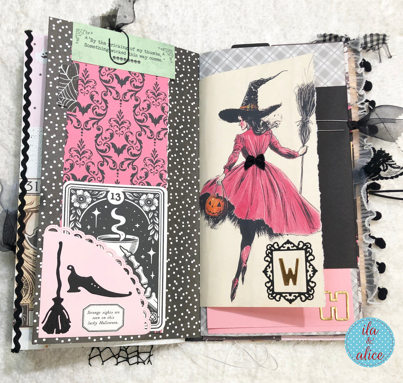 Handmade Pink and Black Halloween junk journal featuring a witch in a pink dress and decorative elements.
