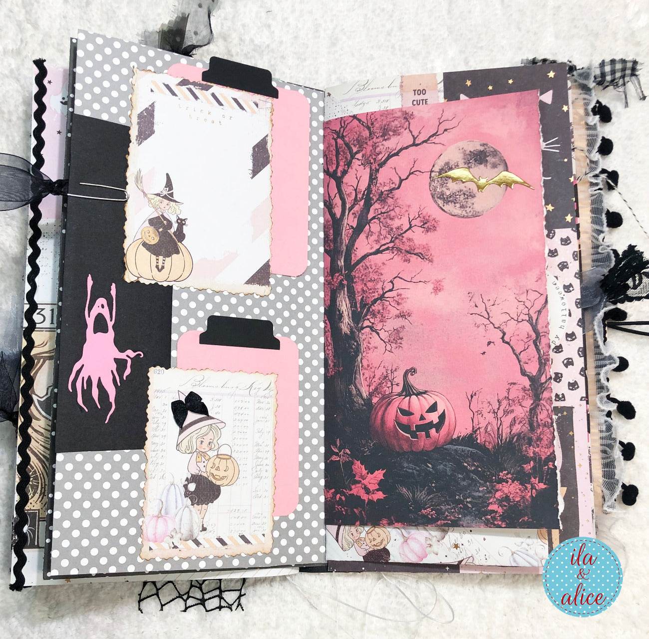 Handmade Pink and Black Halloween junk journal with Halloween-themed pages featuring pumpkins, ghosts, and a witch.