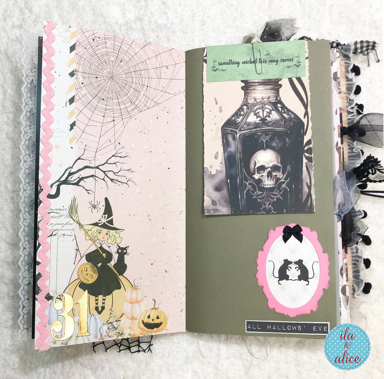 Handmade Pink and Black Halloween junk journal with Halloween-themed design on a textured surface