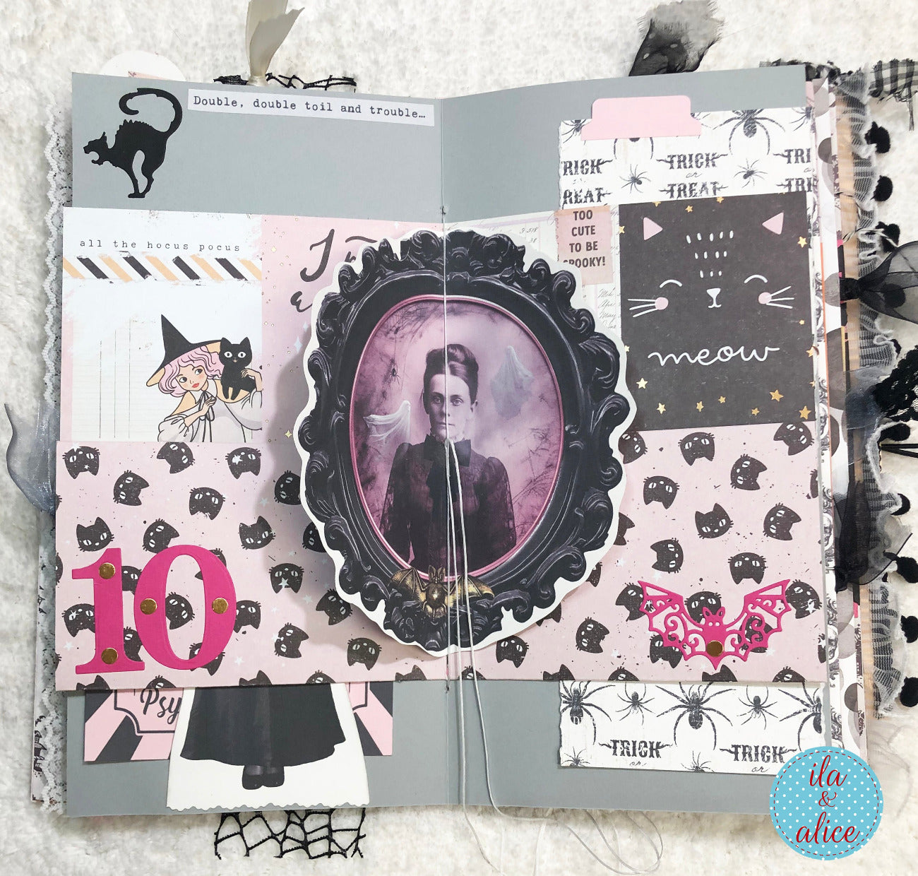 Handmade Pink and Black Halloween junk journal with Halloween-themed pages featuring a vintage portrait, cats, and text.