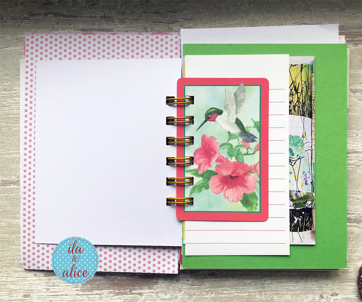 Planner with floral design on a wooden surface, featuring the brand 'ili & alice'.