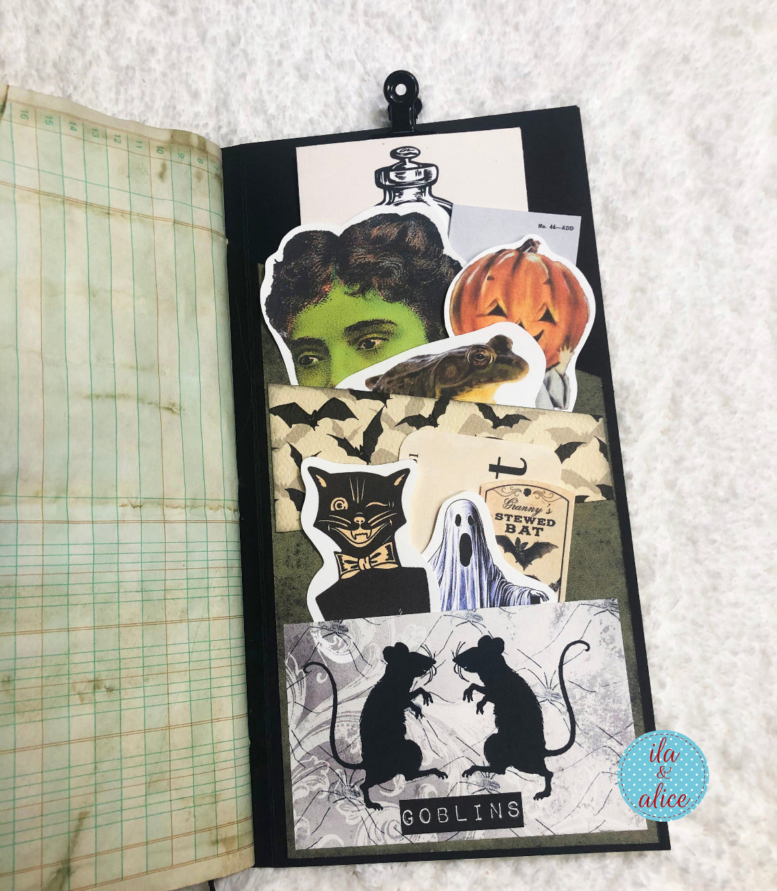 Halloween-themed fussy cuts on a notebook with a textured background