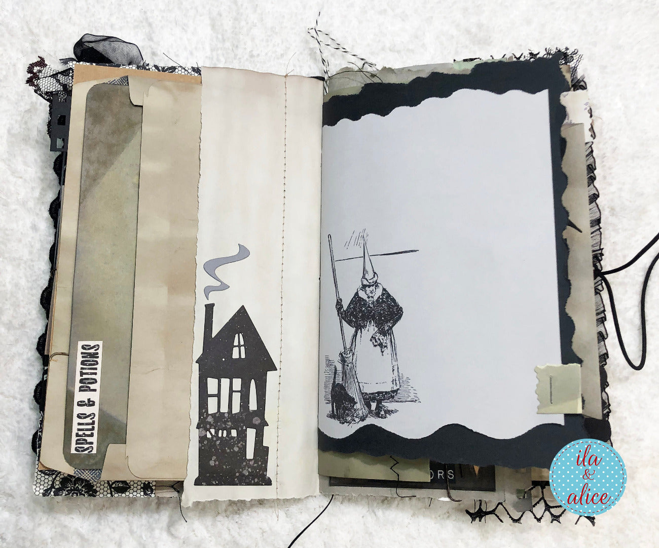 An open handmade scrapbook journal or art book on a white textured fabric background, featuring layered vintage-style pages, black lace trim, a house illustration, and a witch drawing on the right page. A circular 'ita to alice' logo is visible in the bottom right corner.