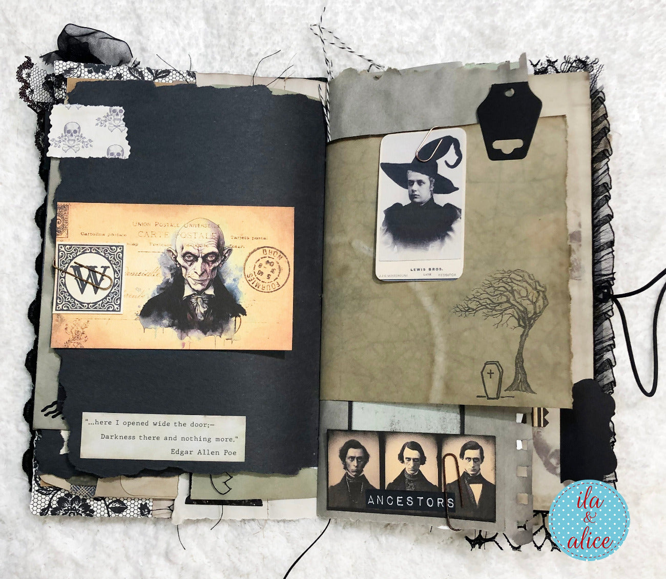 An open handmade scrapbook journal or art book displayed on a white textured fabric background. The left page has black cardstock, lace trim, a vintage-style portrait illustration, a quote card, and small decorative elements.