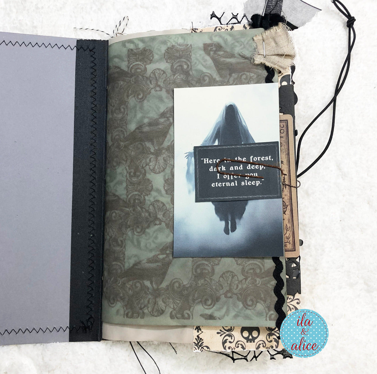 A handmade gothic scrapbook journal page featuring a ghostly illustration with the quote 'Here in the forest, dark and deep.
