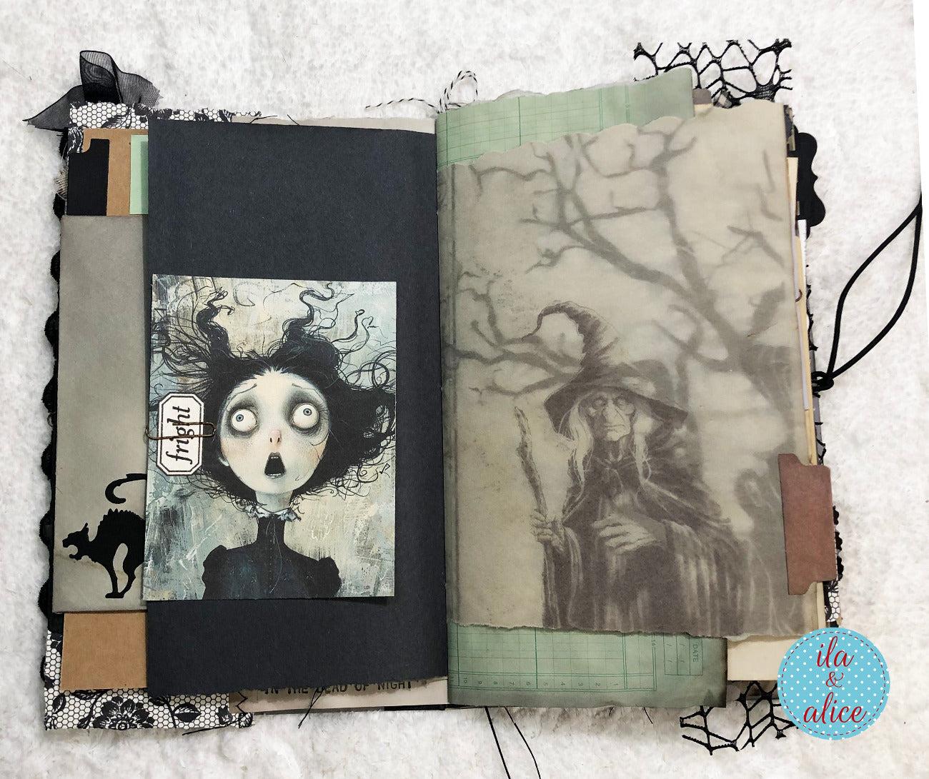 An open handmade art journal featuring a gothic illustration of a witch on the right page and a character card on the left page, styled on a white textured fabric background.