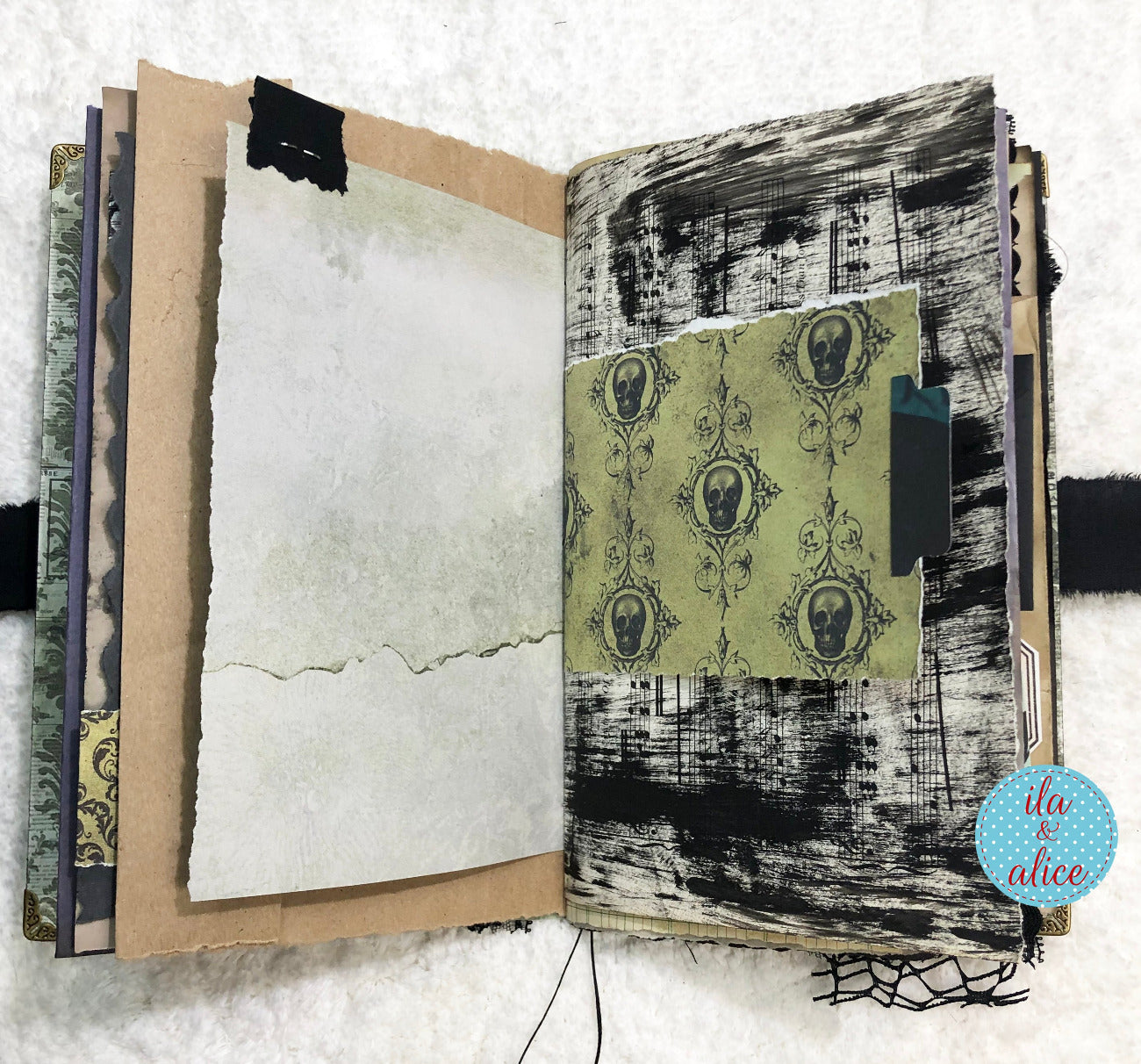 Handmade Eerie Halloween Gothic junk journal with textured pages and decorative cover on a white background