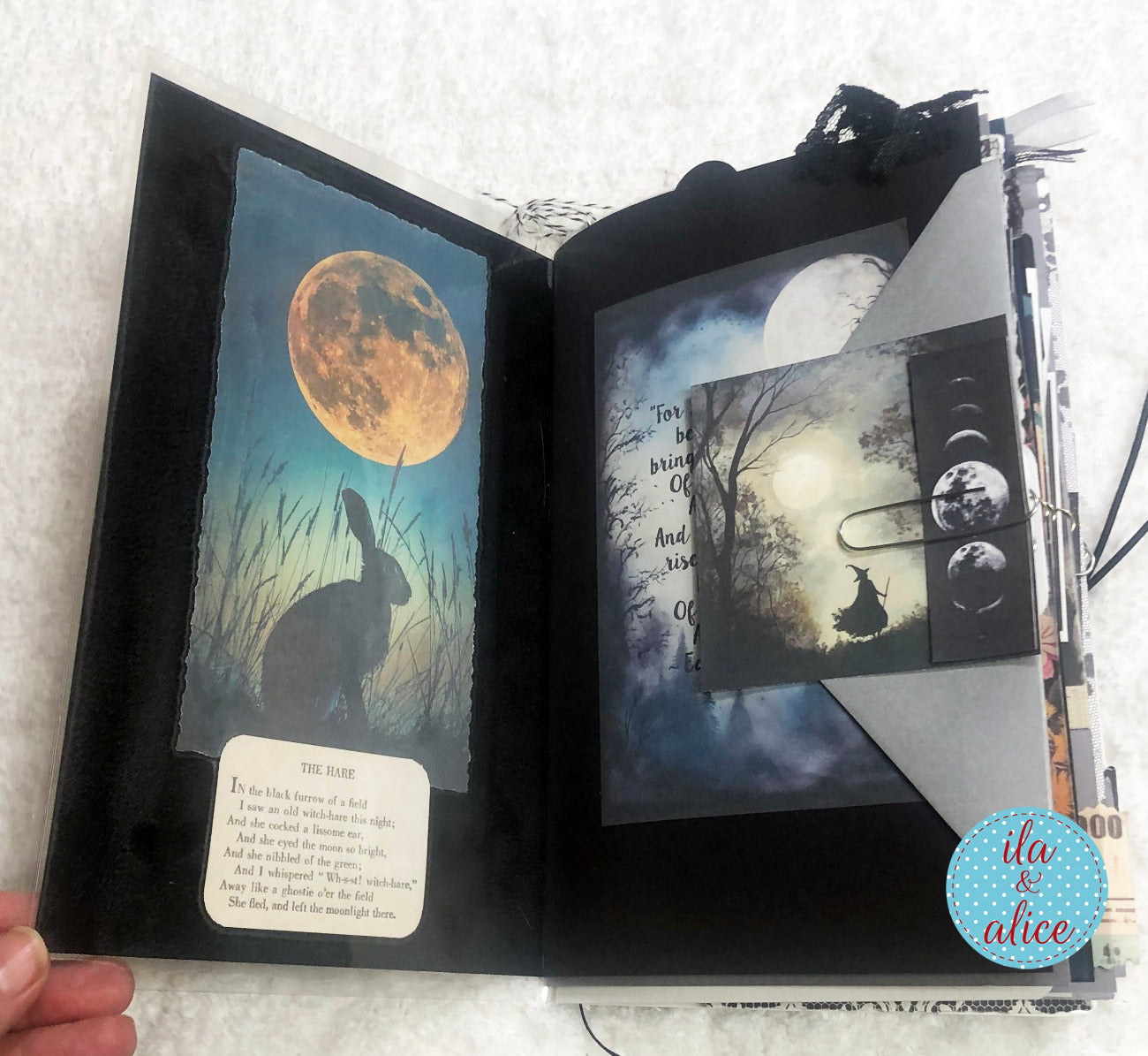 Handmade junk journal with full moon and hare, moonlit landscape and rabbit illustration on a textured surface