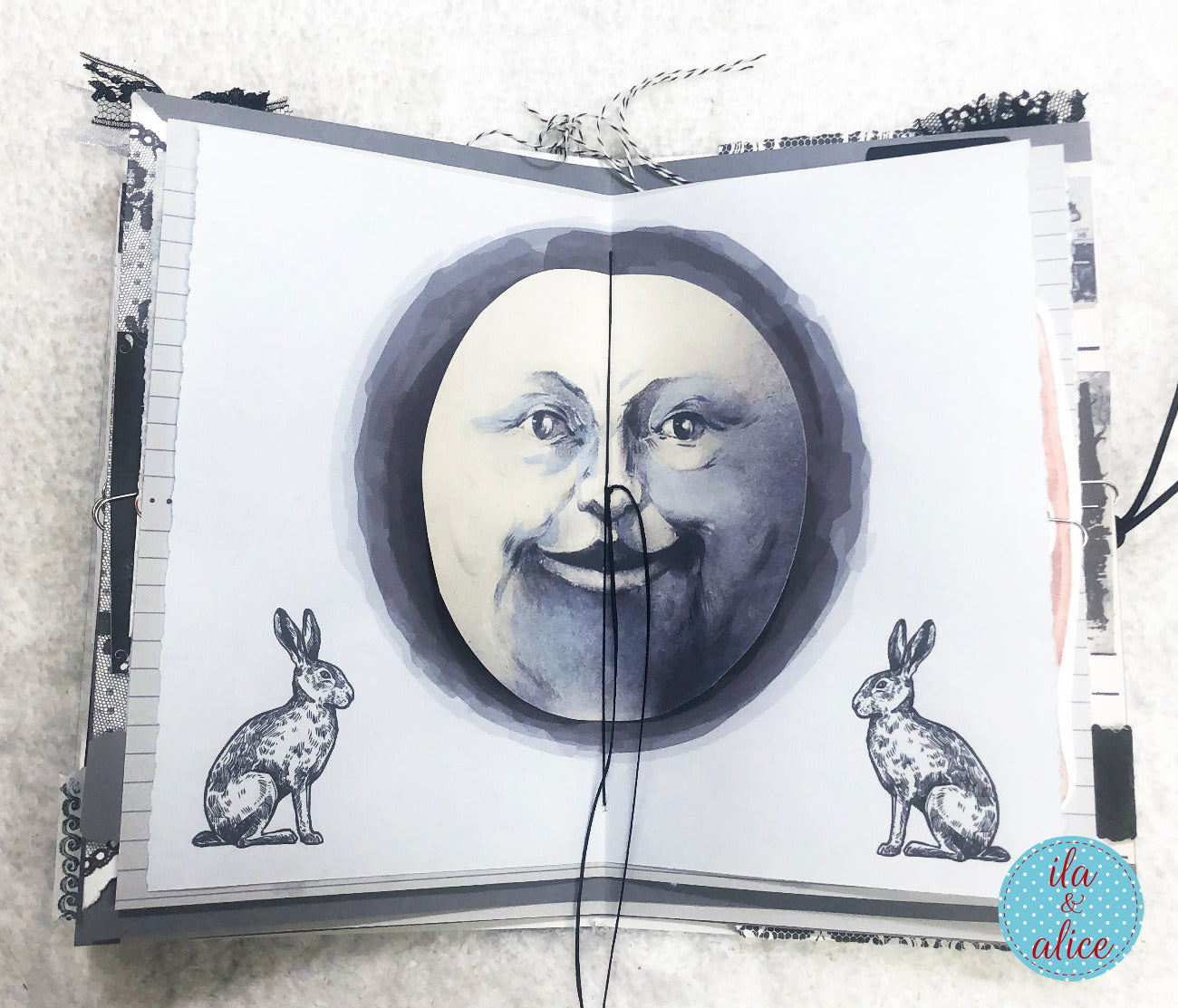 Handmade junk journal with full moon and hare, vintage full moon face and rabbit illustrations on a textured surface