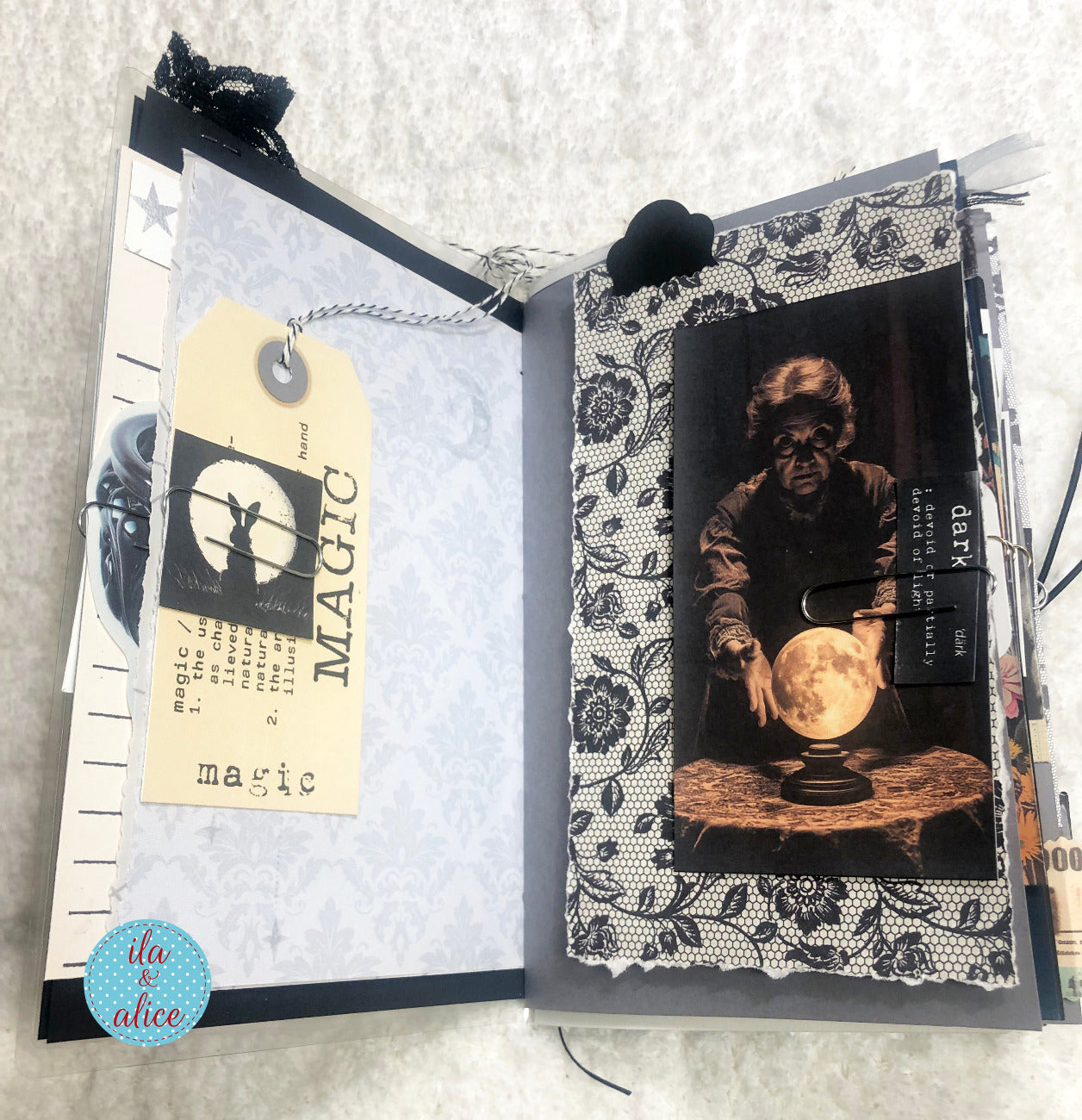 Handmade junk journal with full moon and hare, with black and white design, featuring a tag and image of a person with a crystal ball.