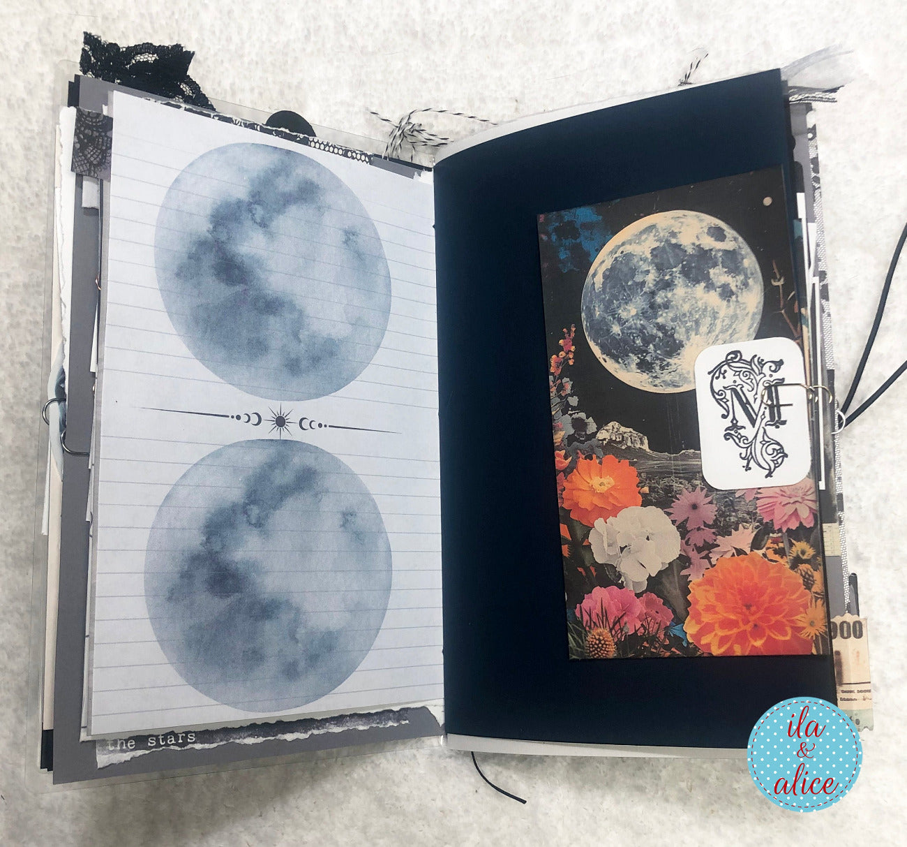 Handmade junk journal with full moon and hare,with moon illustrations and decorative pages on a textured surface.