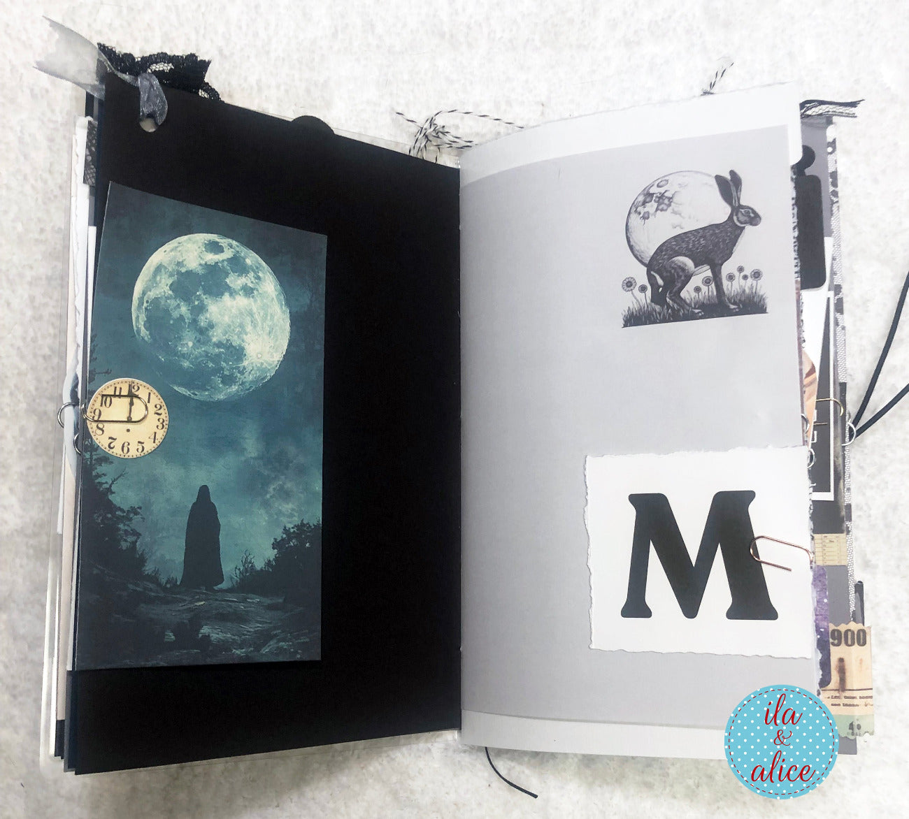 Handmade junk journal with full moon and hare, with illustrations of a moon, rabbit, and letter 'M' on a textured surface.