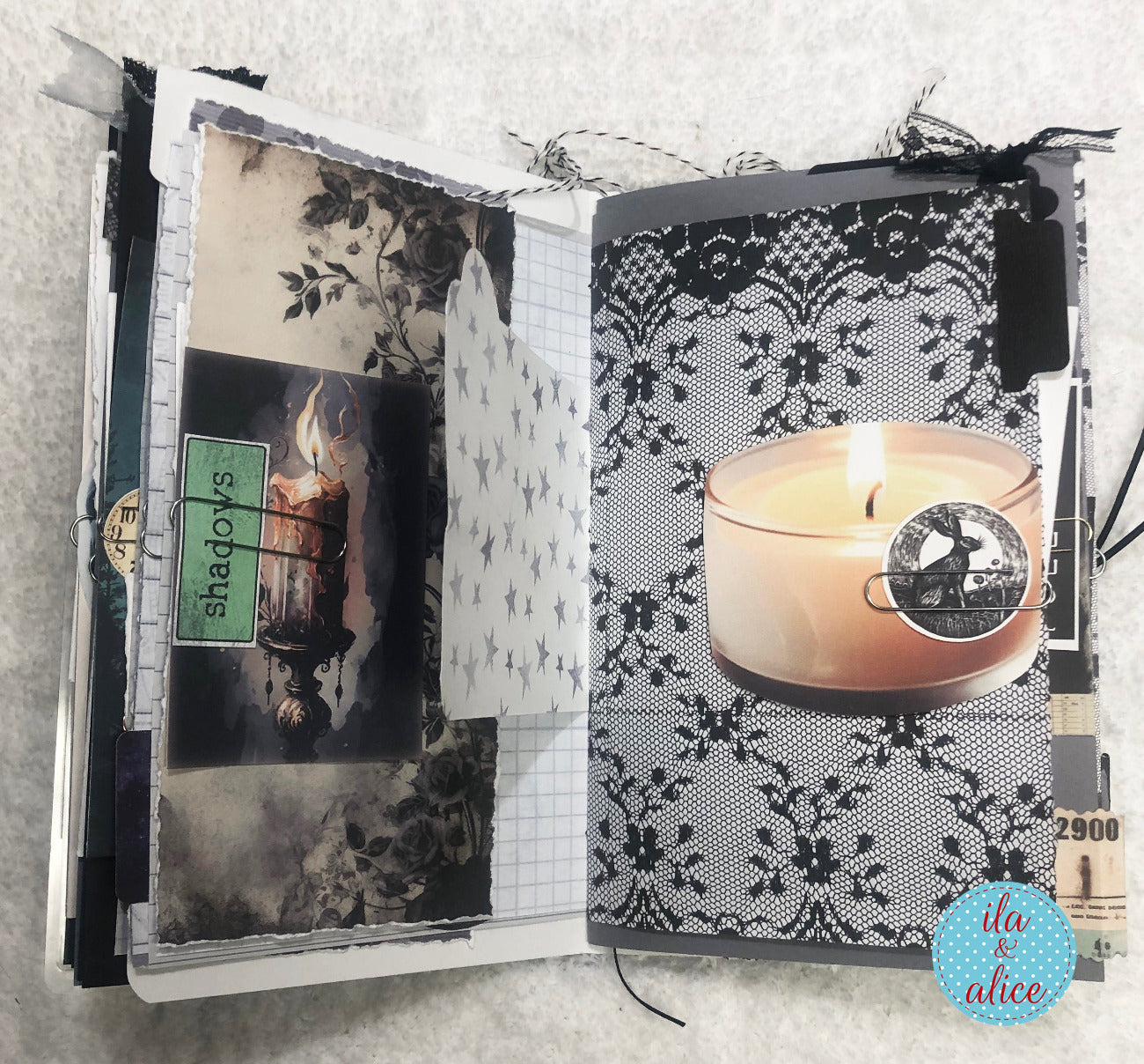 Handmade junk journal with full moon and hare, with decorative pages featuring a candle and lace design.
